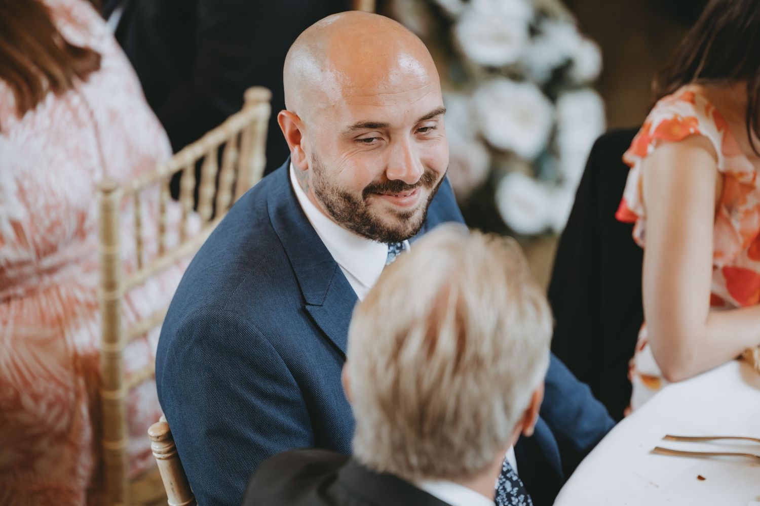 Guests enjoying intimate conversations at elegant wedding reception dinner.