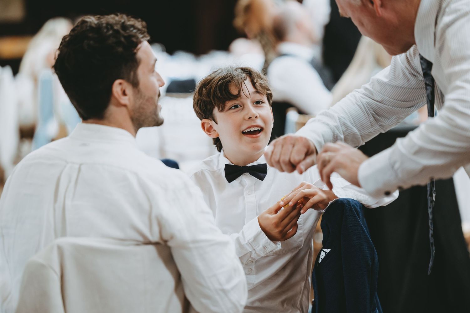 Wedding guests dancing and celebrating during a lively reception party.