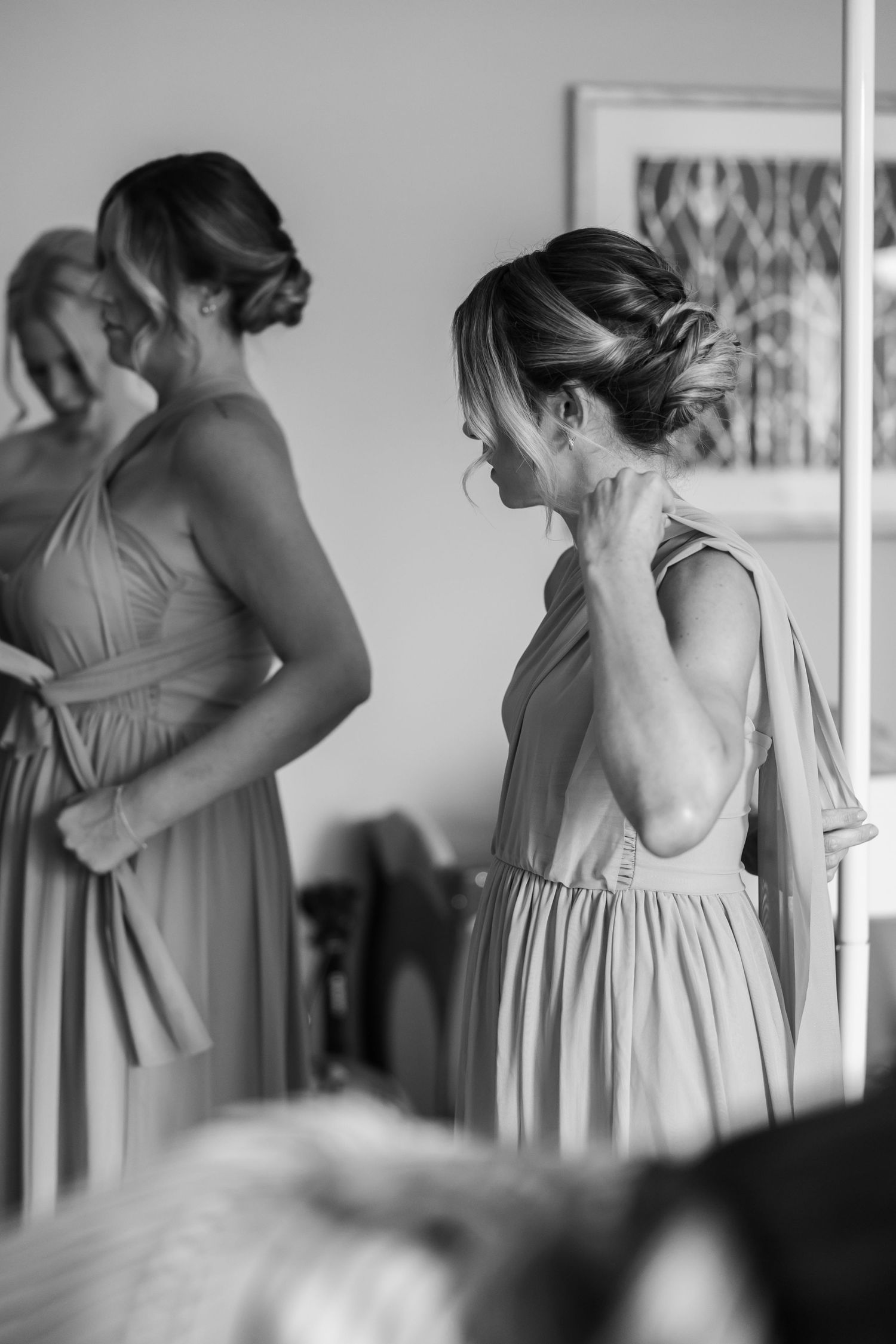 A group wearing matching dresses shown in black and white photography.