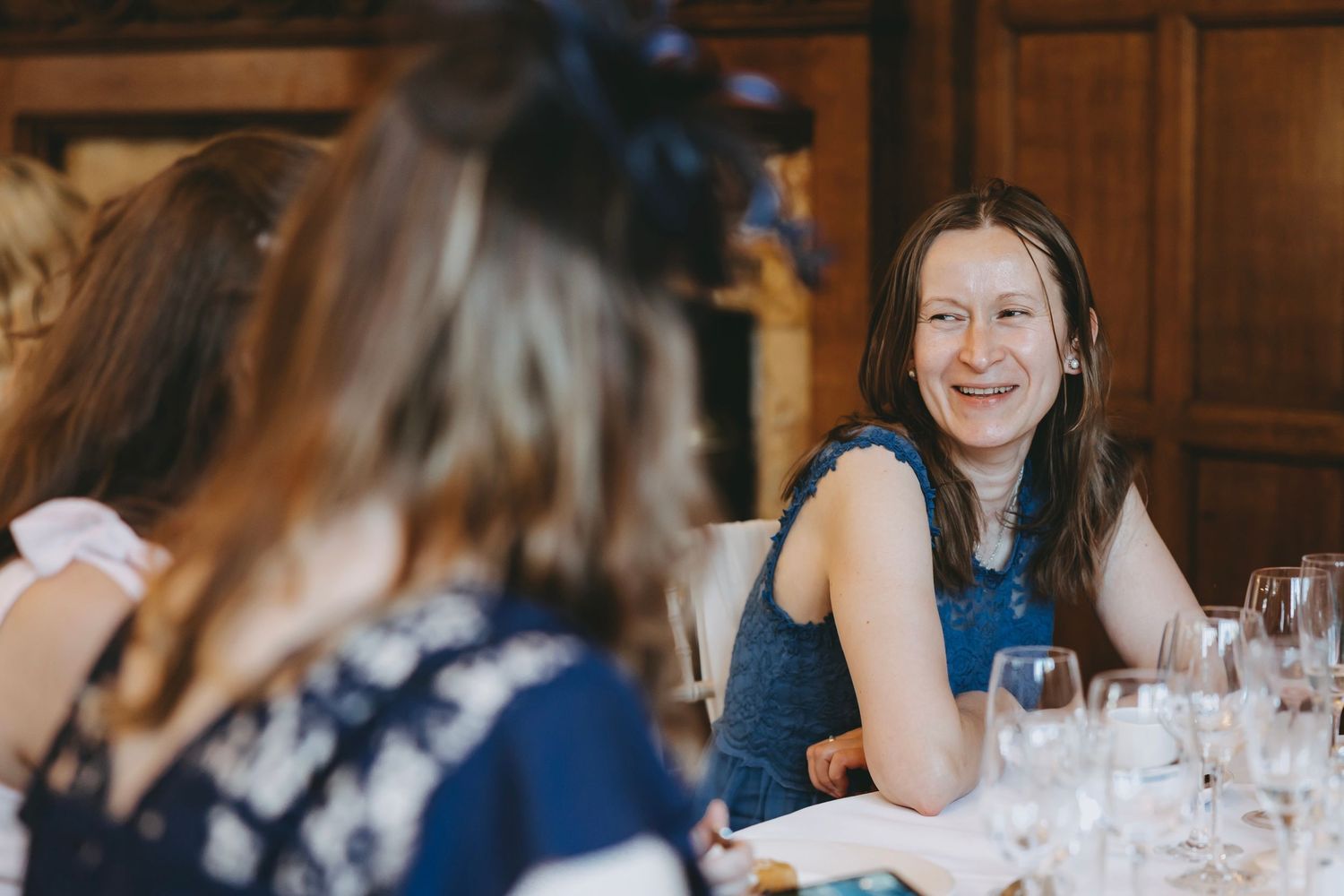 Wedding guests engaged in conversation at elegant reception tables.
