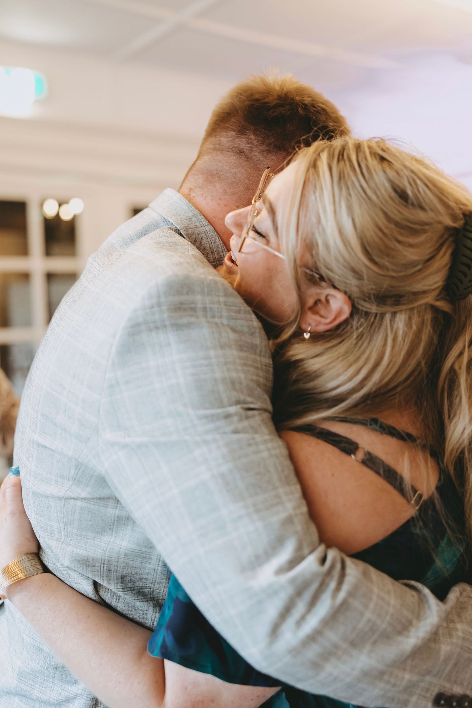 Close-up of an emotional embrace between two people during a special moment.