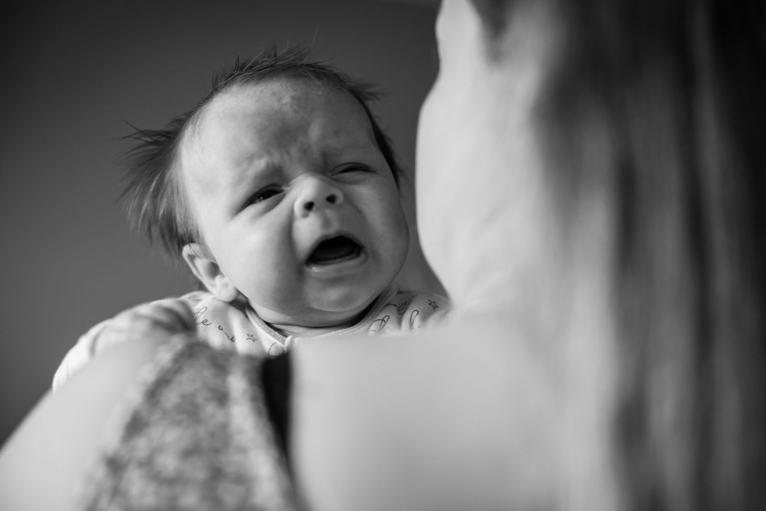 Black and white photo series showing a baby's changing expressions and emotions.