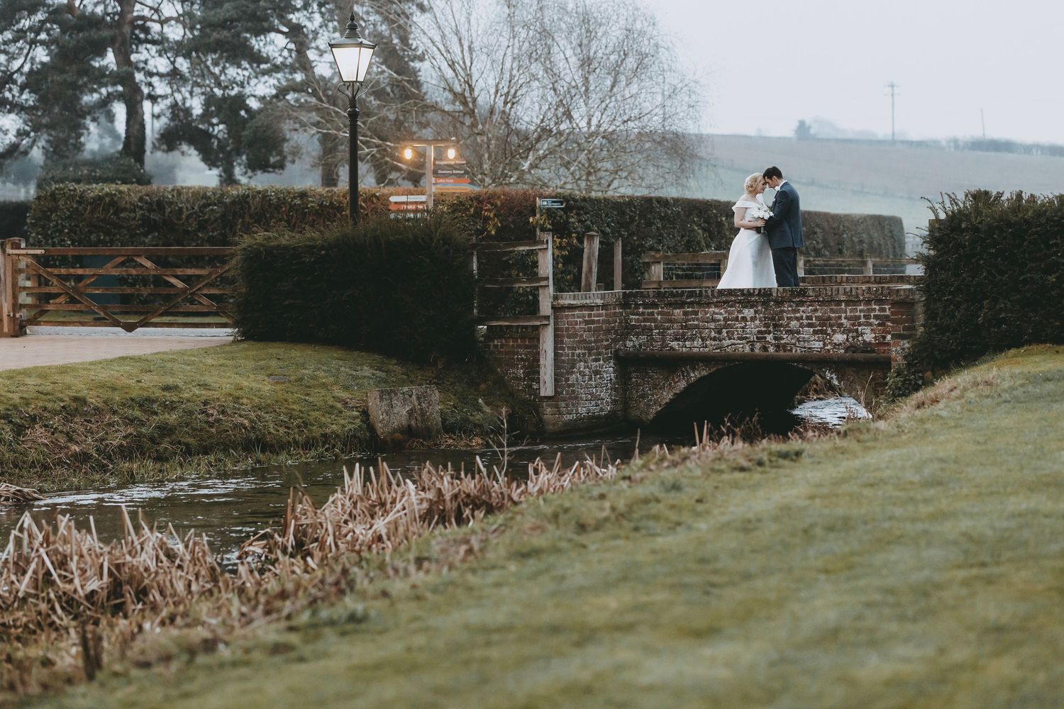 Scenic outdoor wedding venue with stone architecture and natural landscape views at Tewinbury Farm, Hertfordshire.