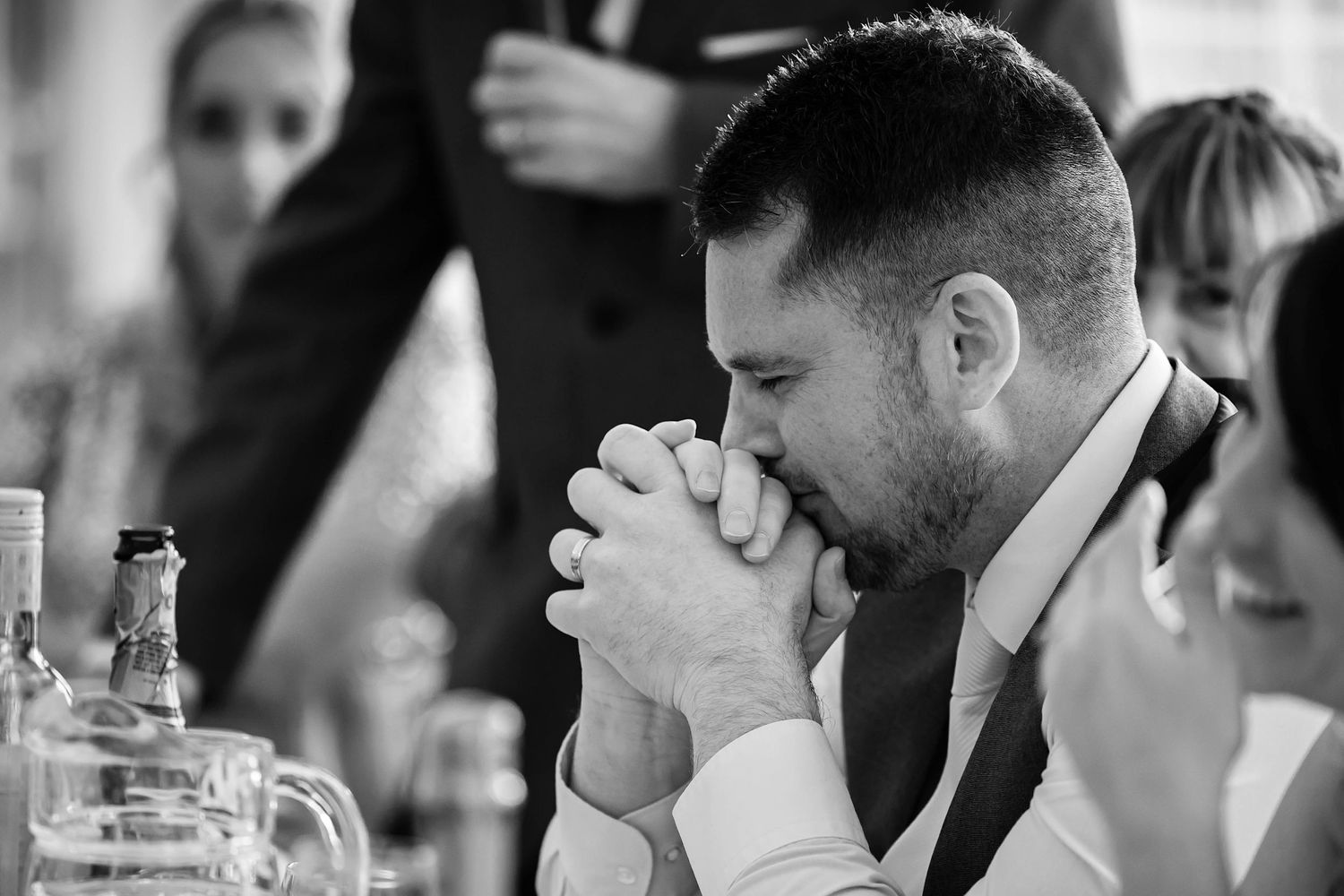 Wedding guests share laughter and conversation during an intimate reception celebration.