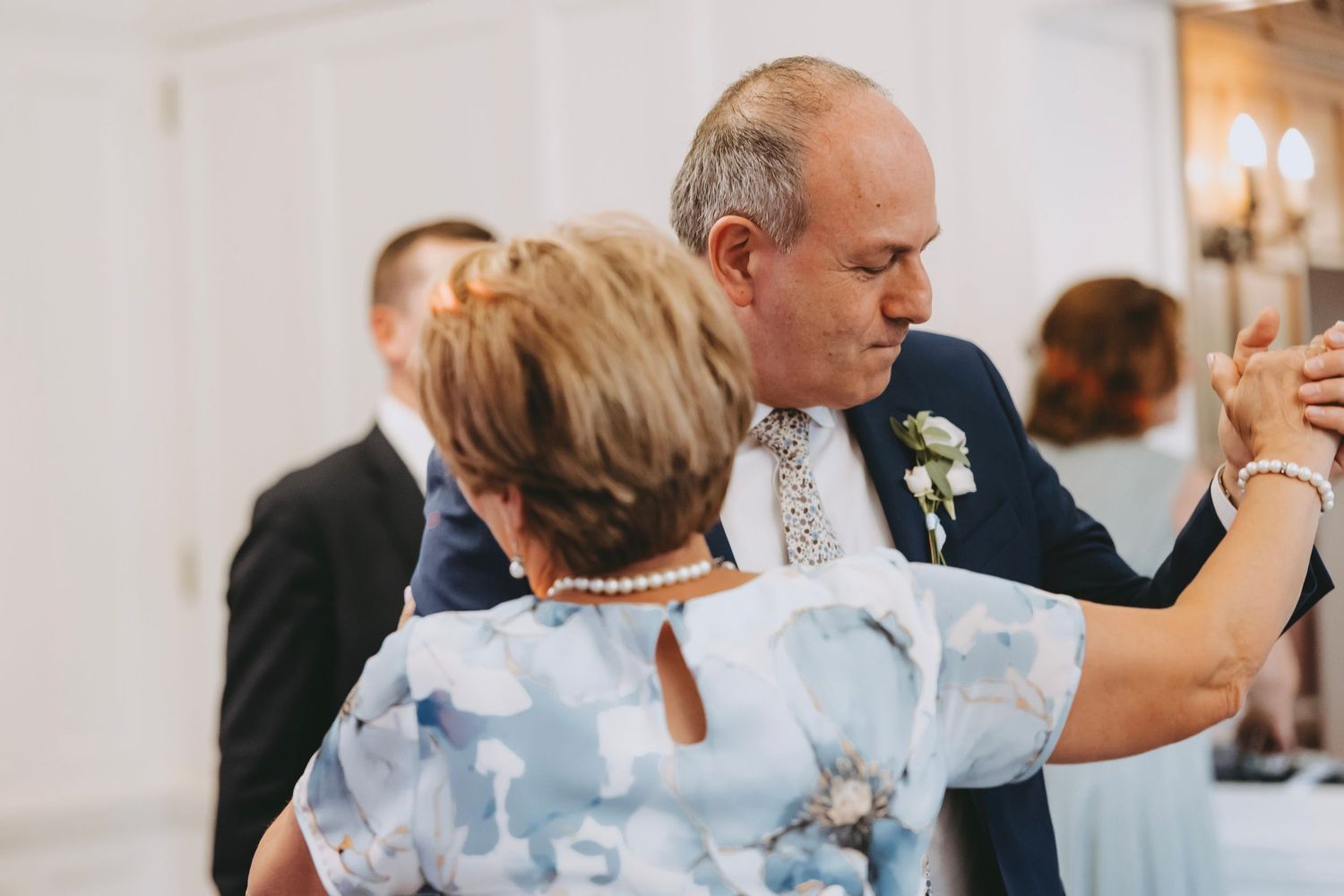 Guests share intimate dances during an indoor wedding reception.
