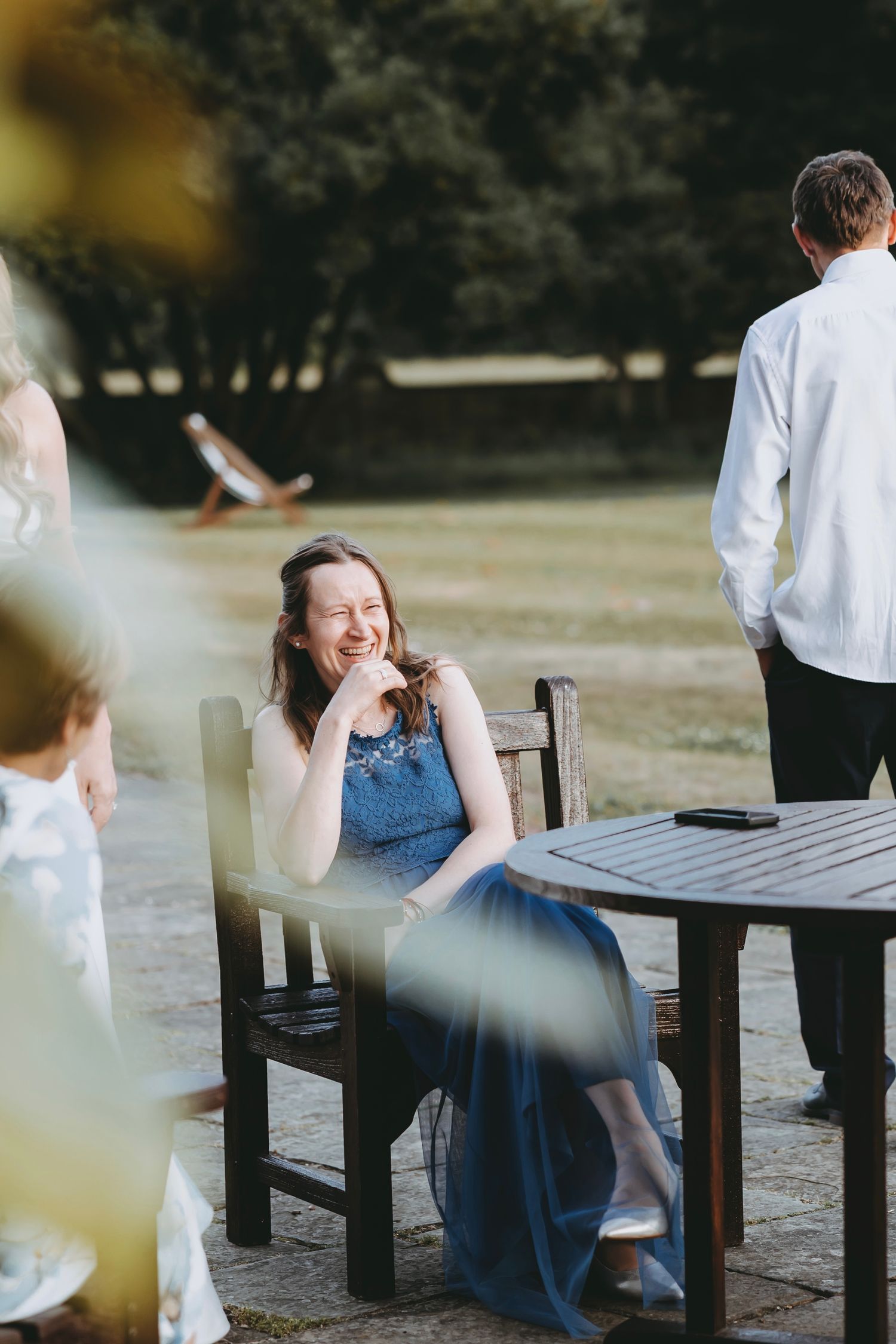Outdoor seating area with wooden benches arranged for a social gathering.