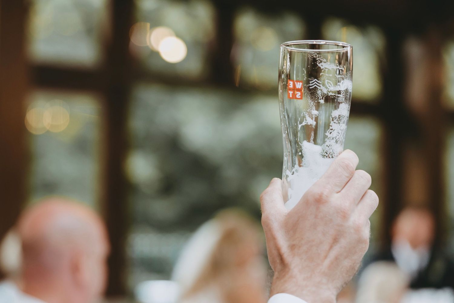 Raised champagne glasses during a wedding toast celebration.