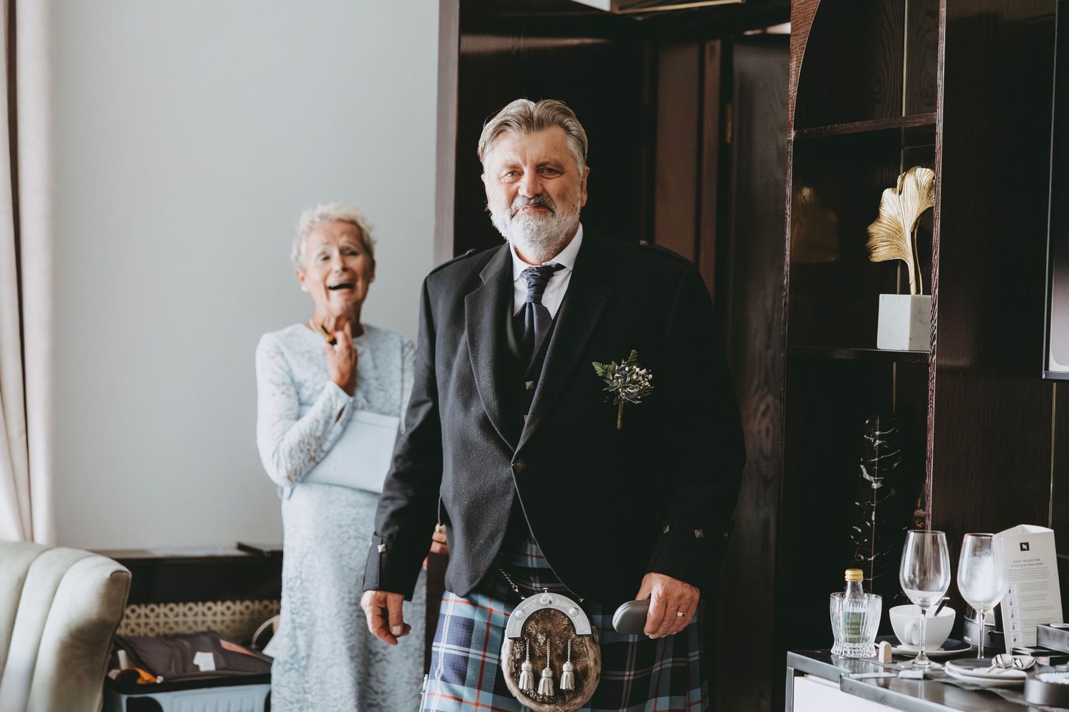 Candid black and white photo of wedding day preparations.