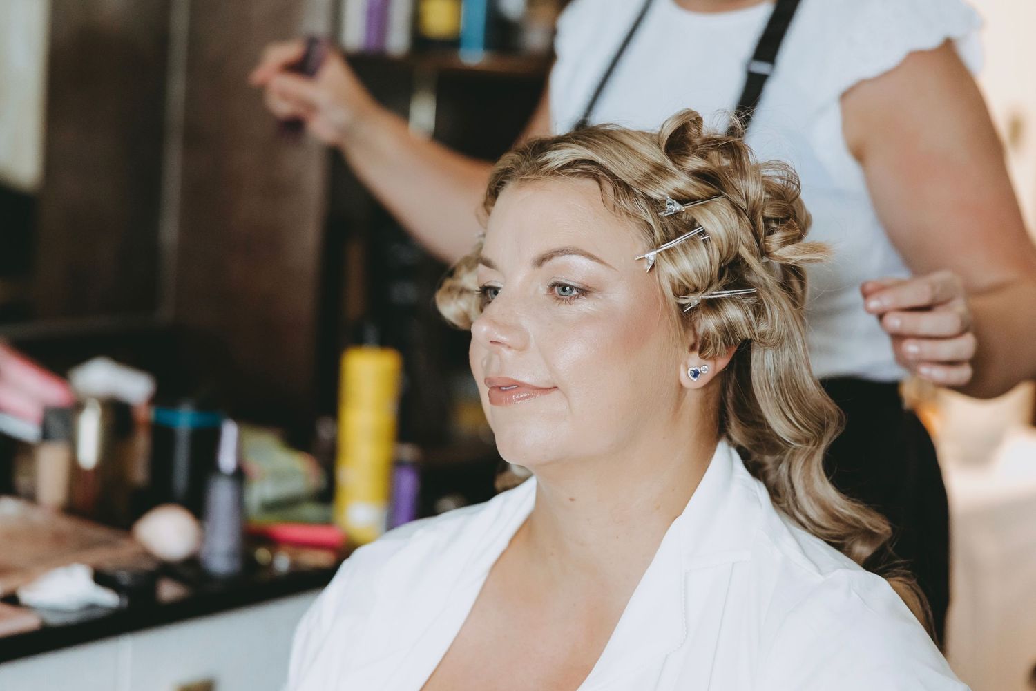 Person getting hair and makeup done in preparation for an event.