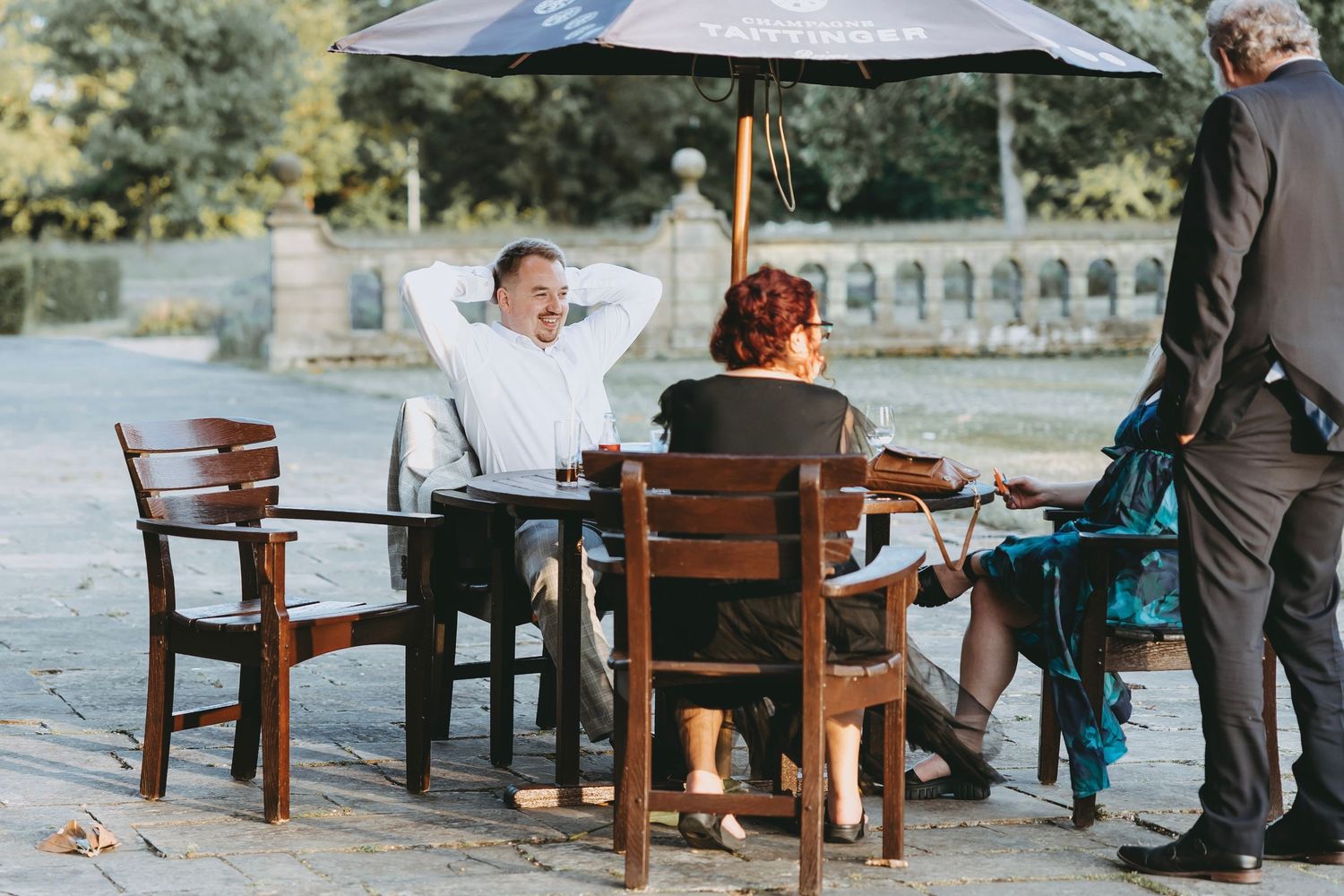 Row of patio umbrellas shading outdoor seating area at an event venue.
