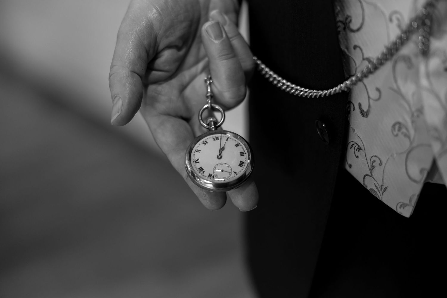 Vintage pocket watch detail shot in black and white.