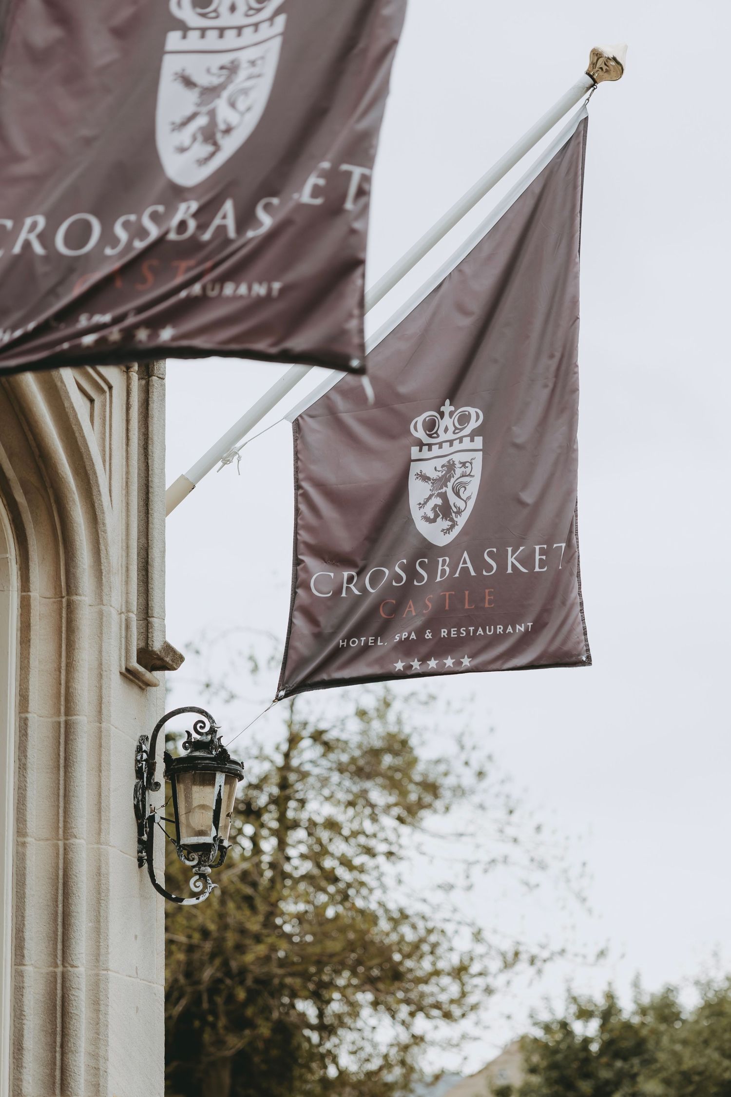 Crossbasket branded banners and flags displayed outside a luxury venue.