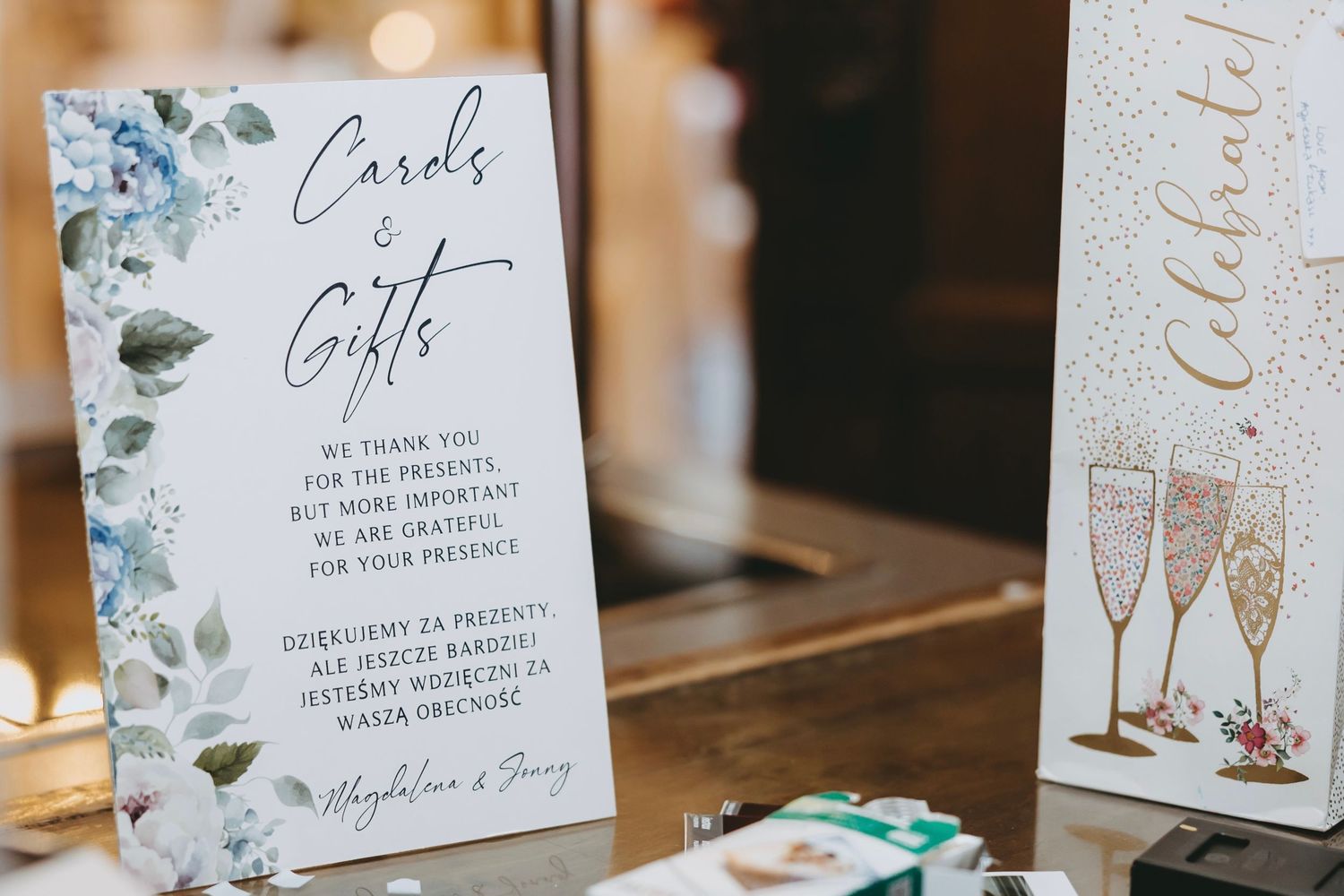 Wedding signage and decorative cards with floral designs and champagne illustrations.