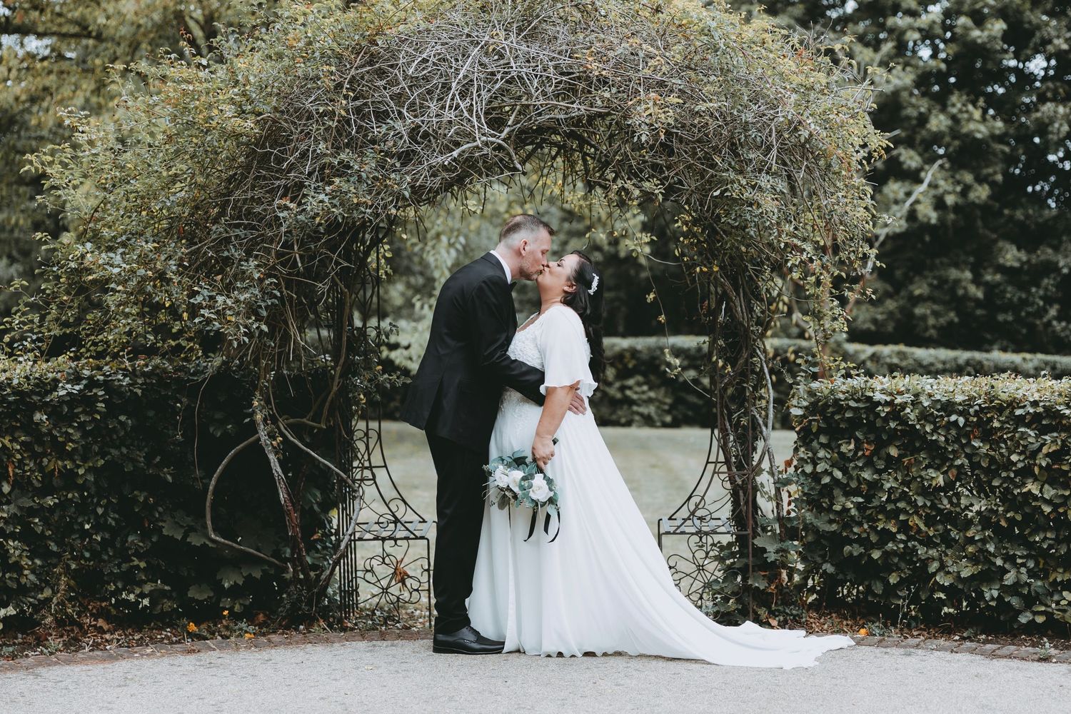 Garden wedding ceremony site with lush greenery and natural landscaping.