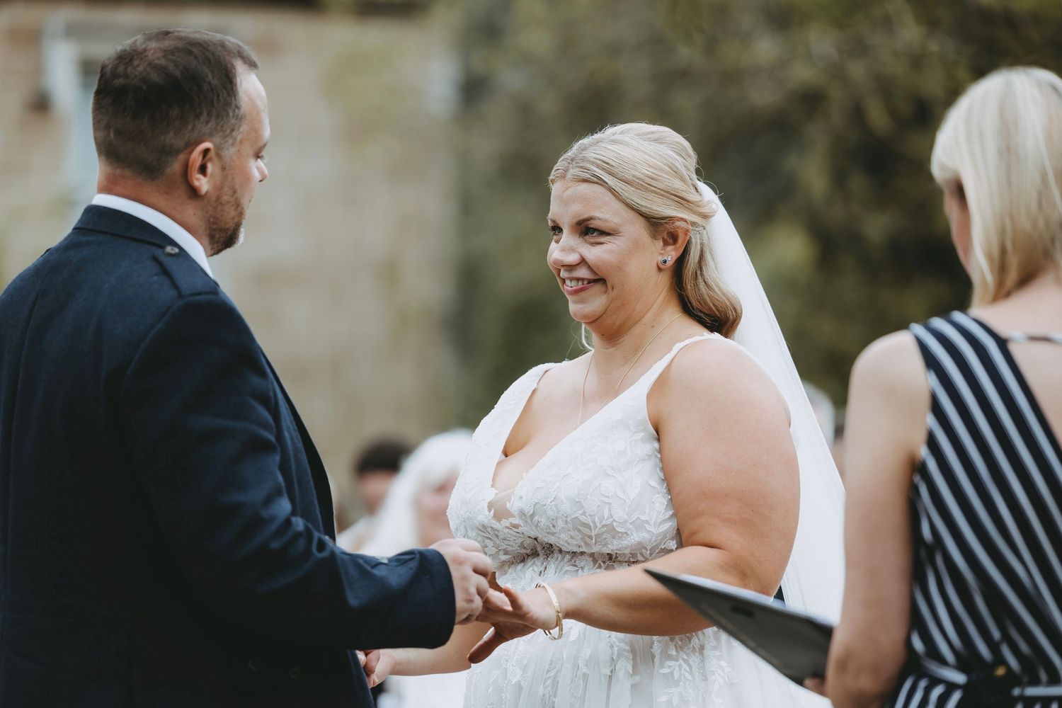 Close-up shots of wedding ceremony moments with guests in formal attire.