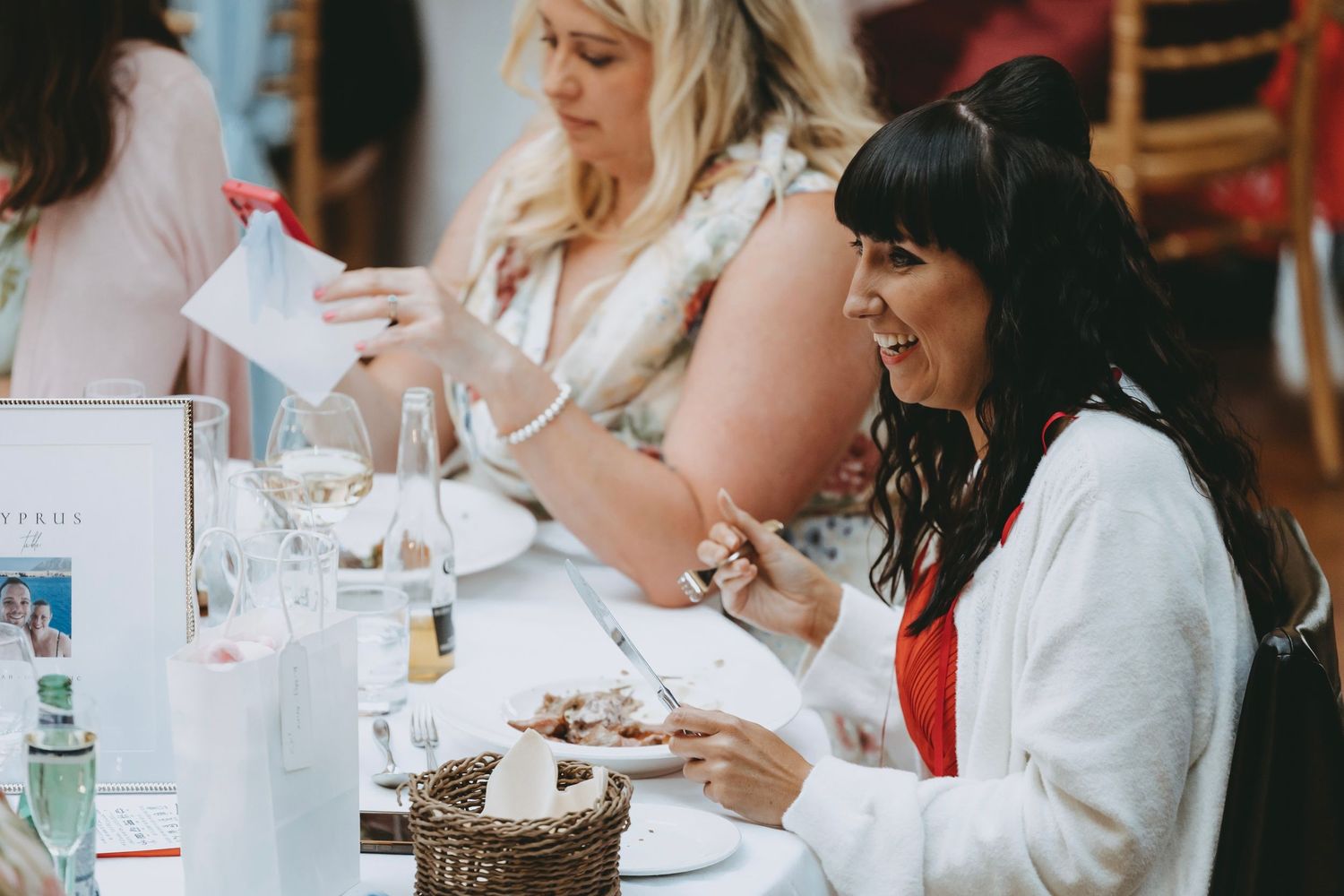 Guests enjoy their meals at an elegant wedding reception table.