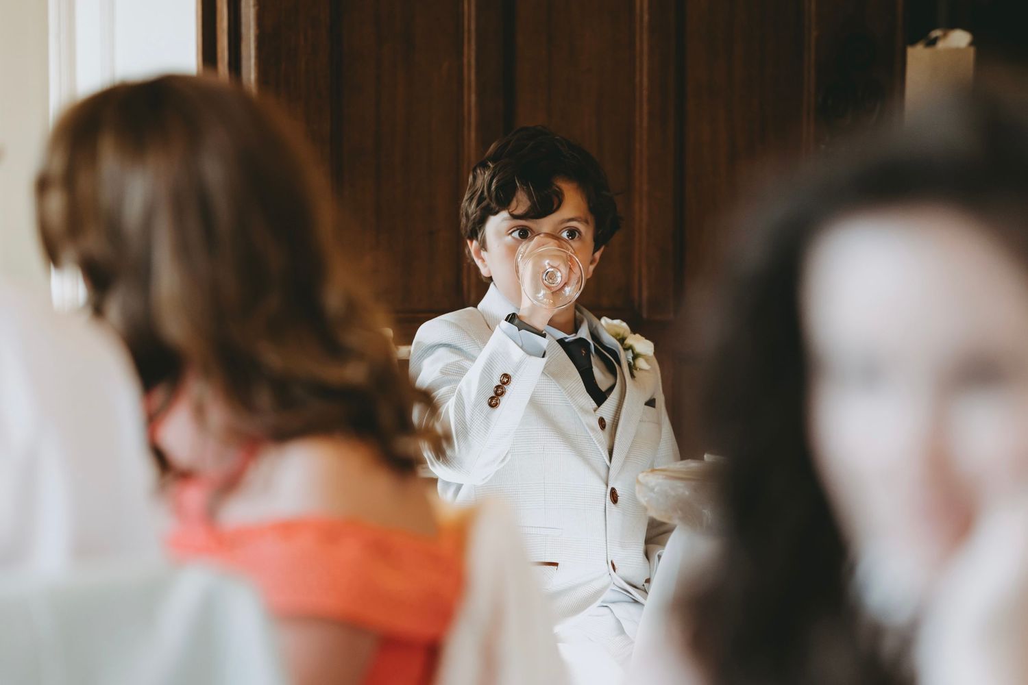 Guests mingling at an elegant indoor reception with classic decor.