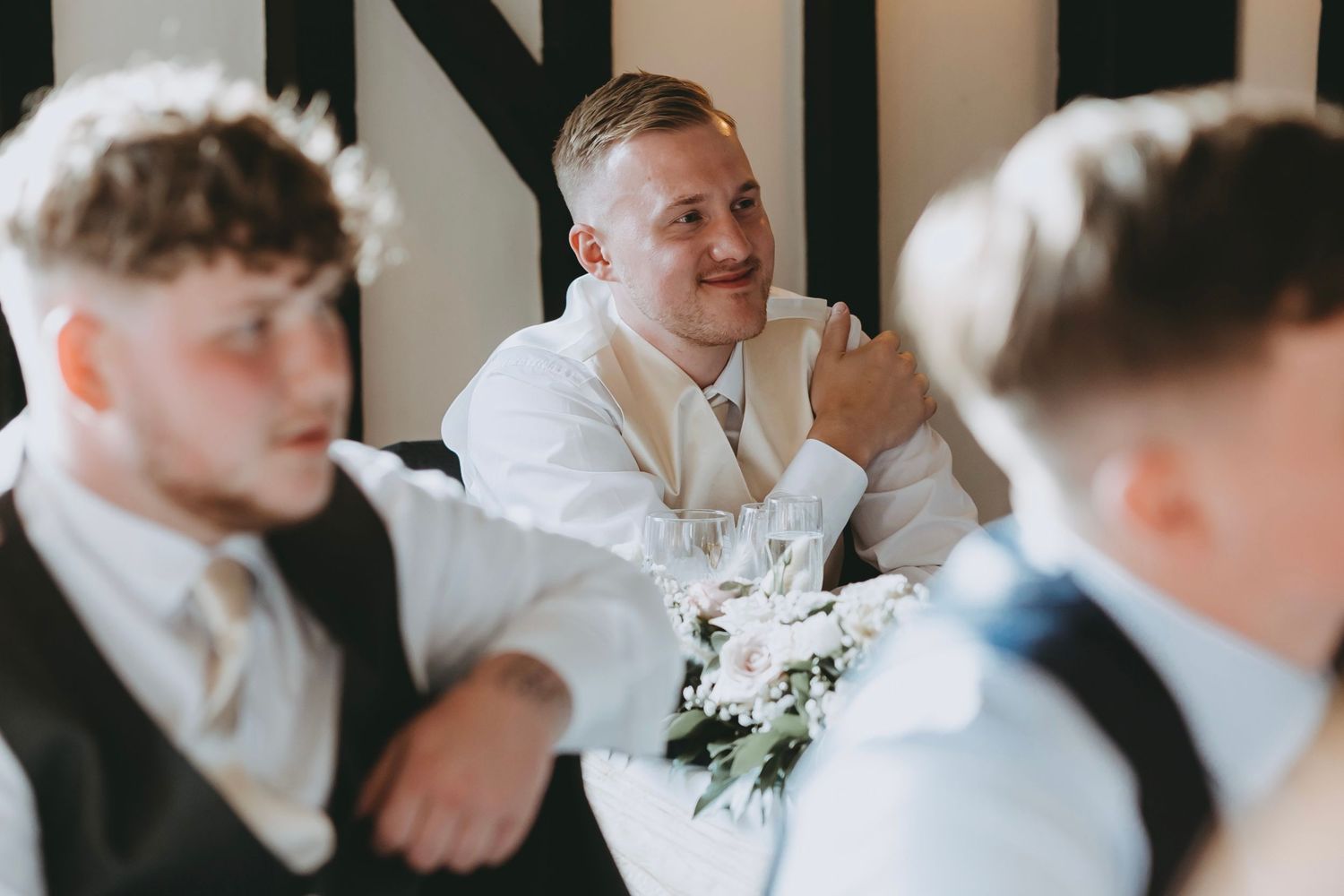 Candid reactions of wedding guests during emotional reception speeches.