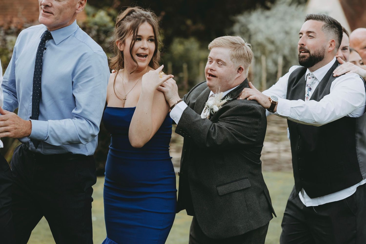 Wedding guests dancing and celebrating together at an outdoor reception.
