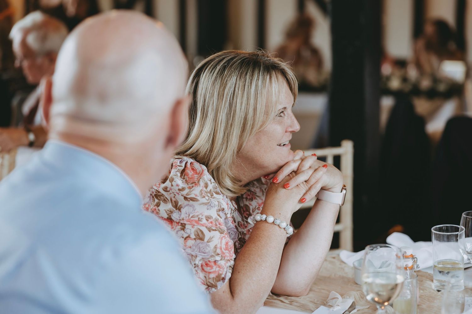 Guests listen attentively during emotional wedding reception speeches.