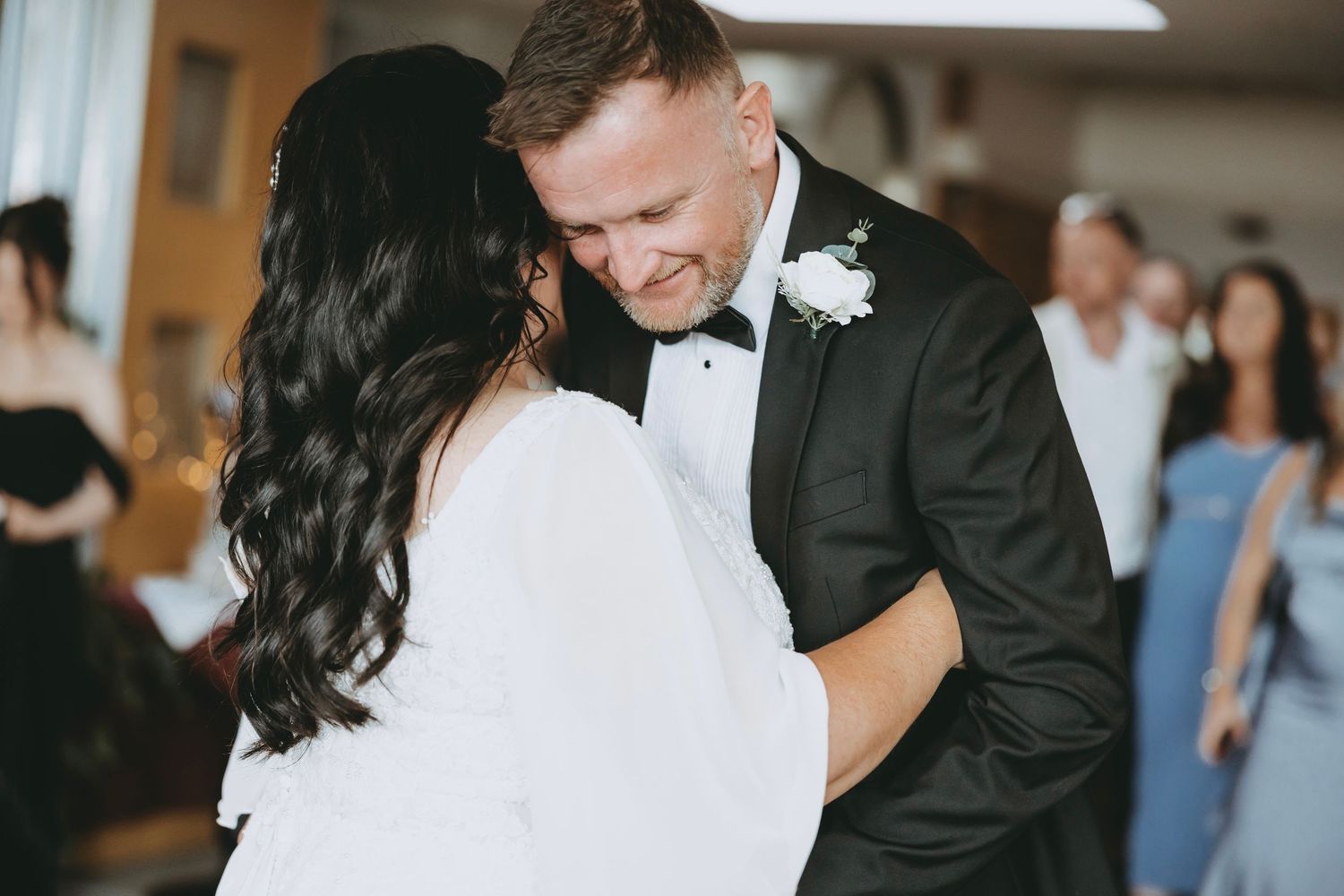 Elegant wedding ceremony in a rustic indoor venue with romantic lighting.