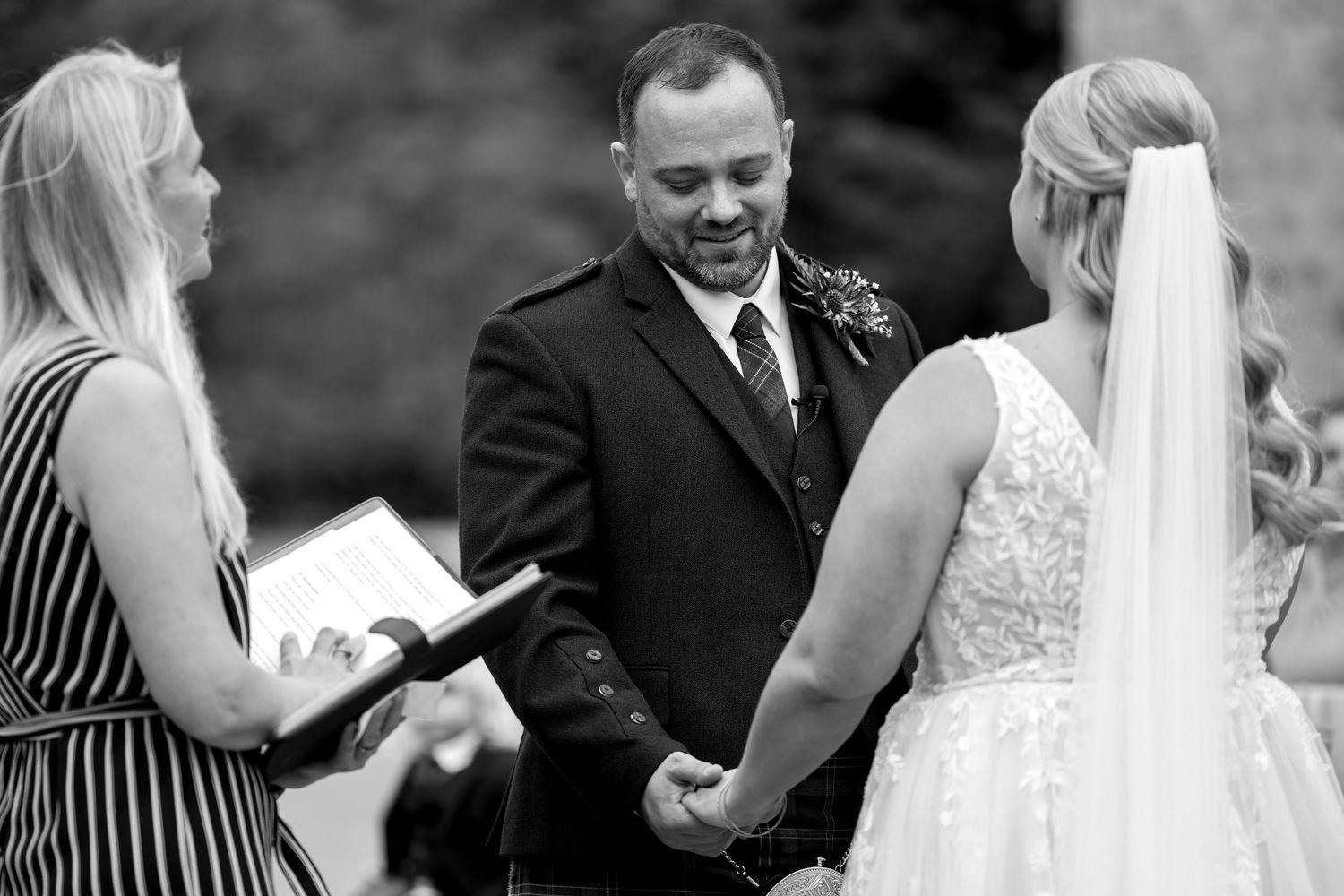 Intimate moment captured during outdoor wedding ceremony with Scottish elements.