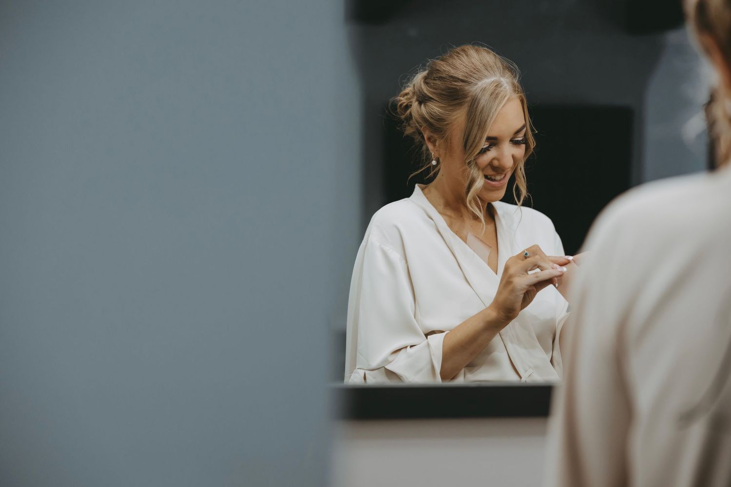 Candid moments captured during wedding day preparations in soft lighting.