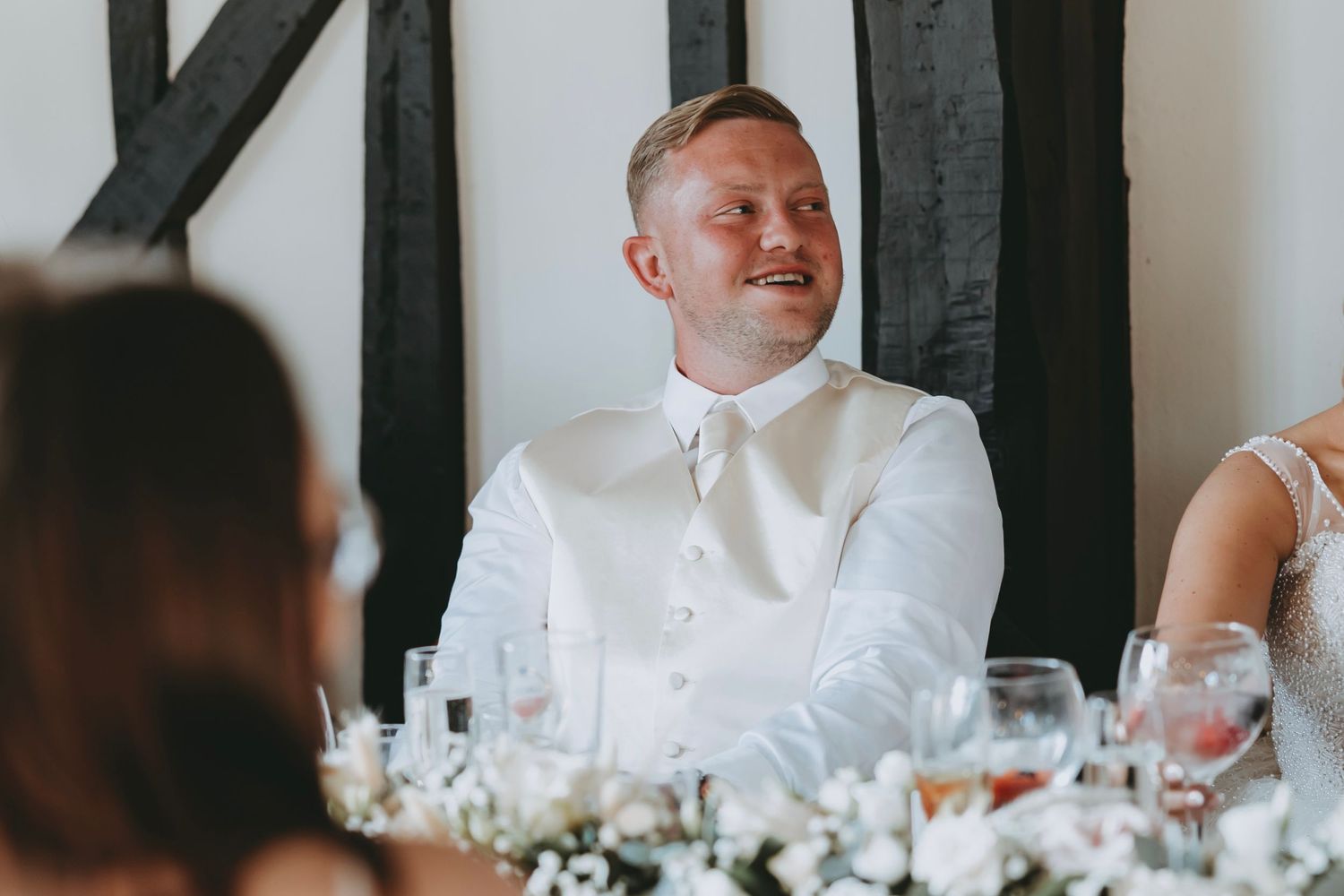 Joyful moment captured during wedding reception dinner.