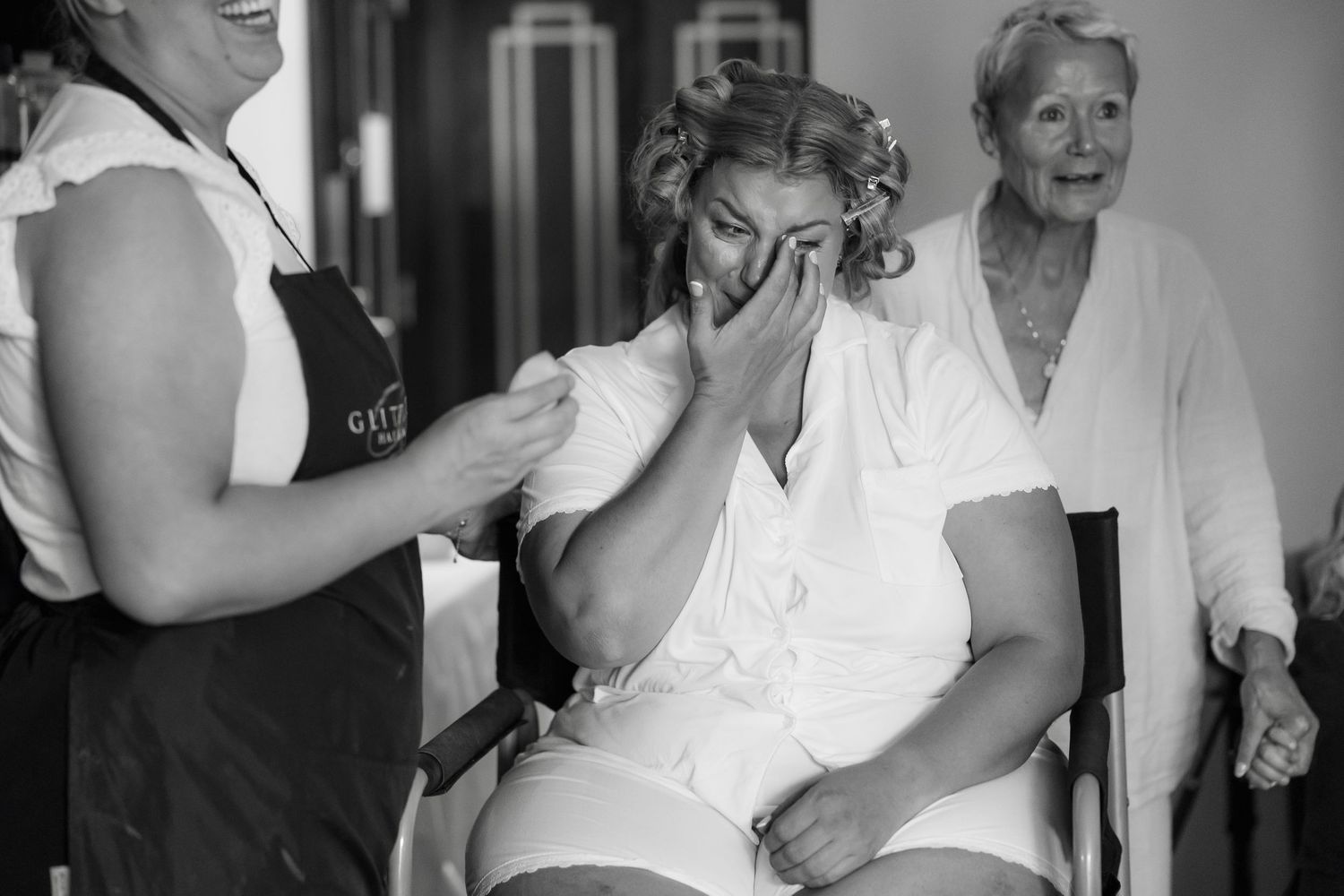 People interacting during bridal prep with natural lighting.