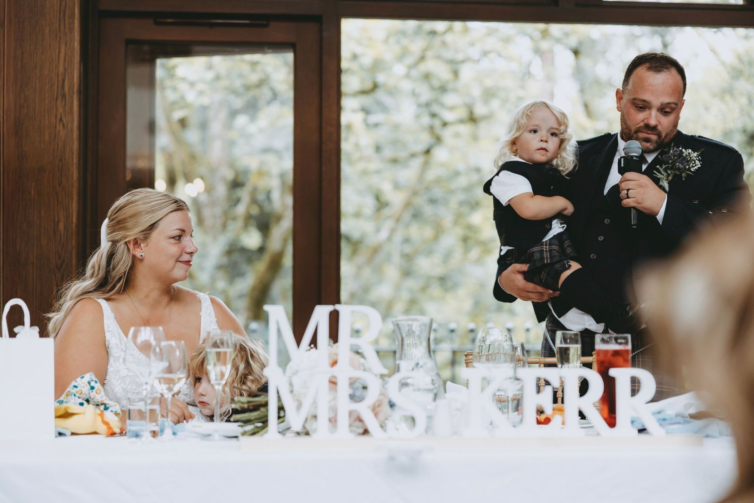 Wedding reception table with 'Mr & Mrs' signage and elegant place settings.