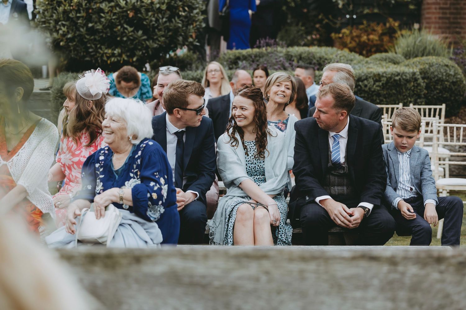 Wedding guests gathered outdoors for a casual reception.