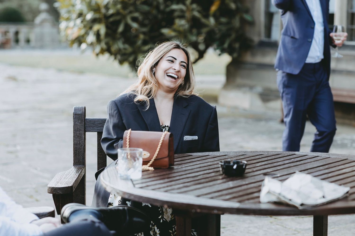 A joyful wedding scene captured outdoors with natural lighting and laughter.