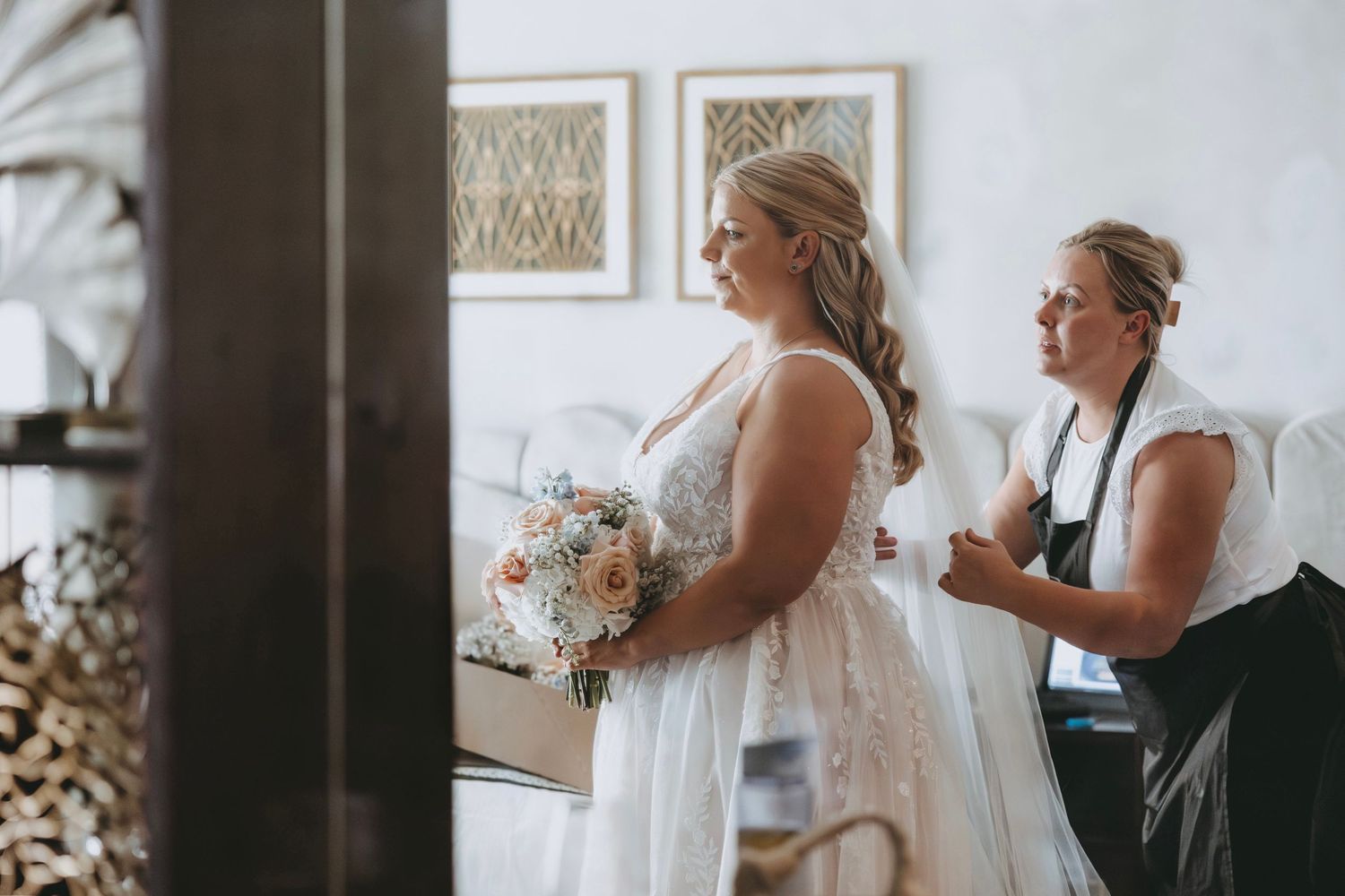 Emotional wedding preparation moment captured in natural light.