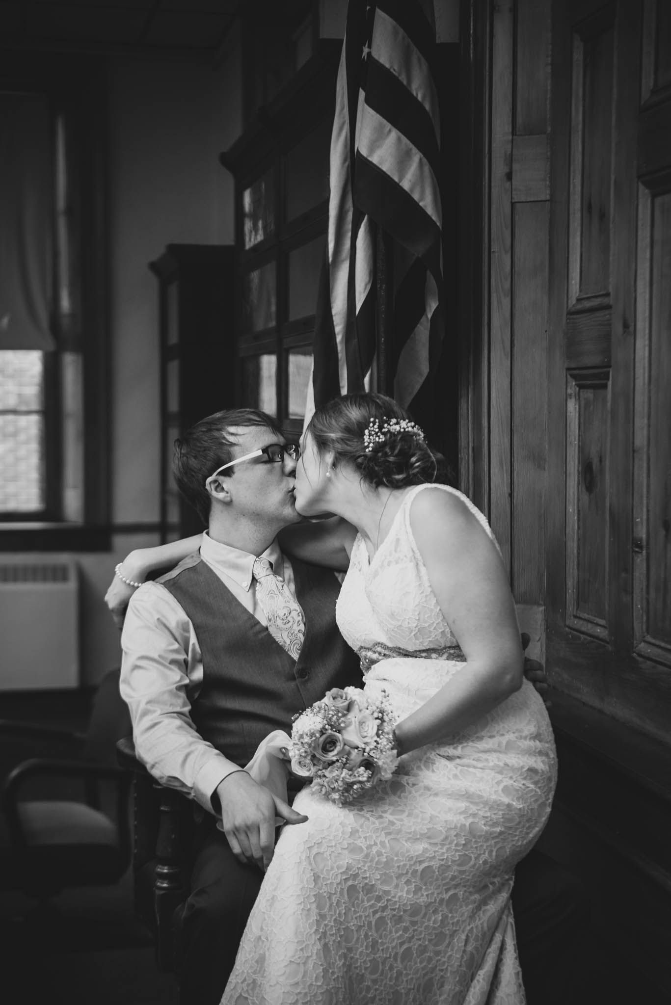 Black and white wedding photos showing tender moments in a dimly lit hallway.