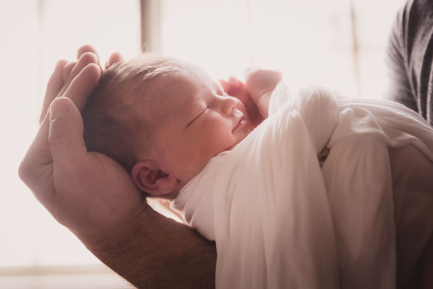 Soft, minimalist newborn portraits in natural window light.