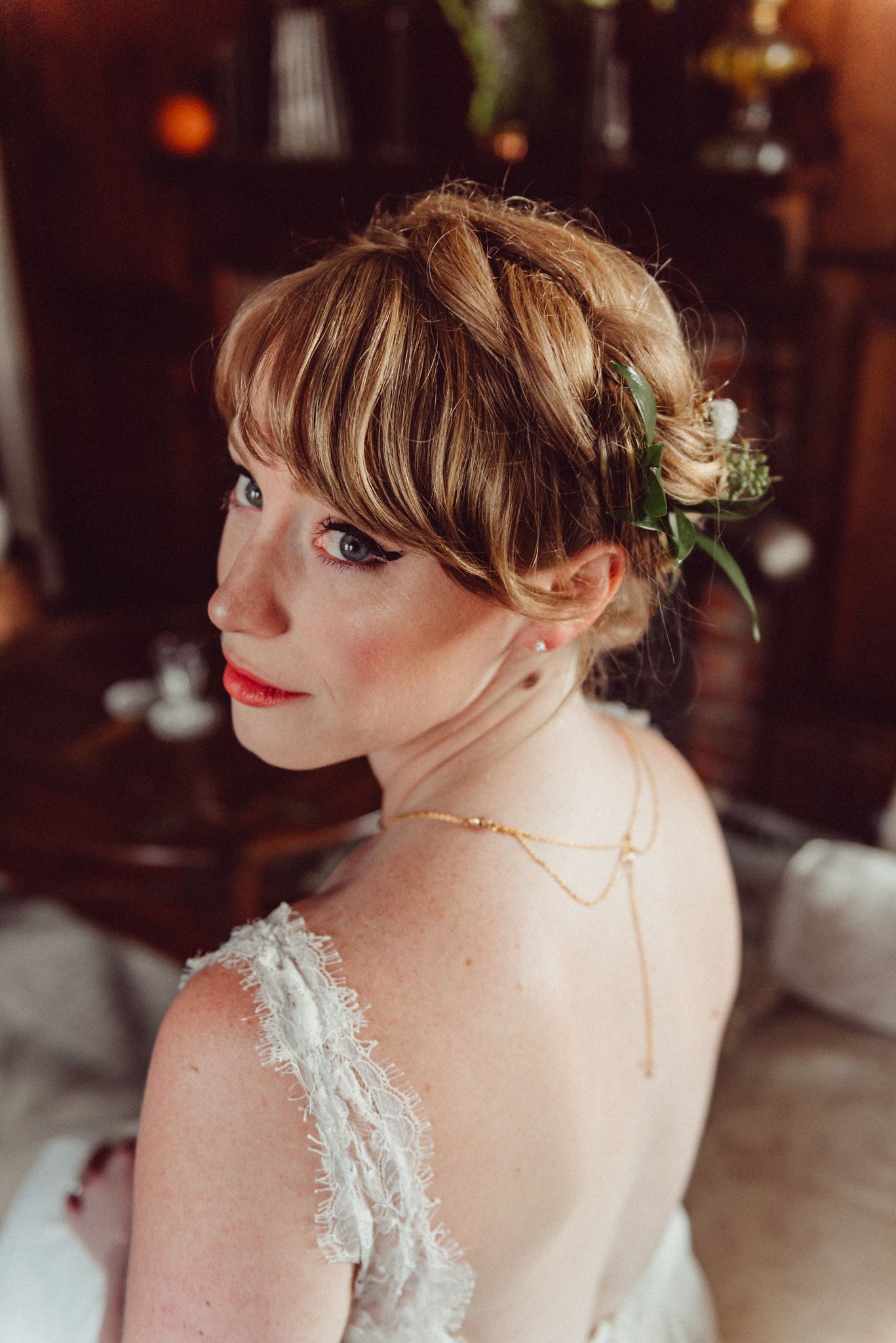 Close-up portraits showing delicate lace details of a wedding dress.
