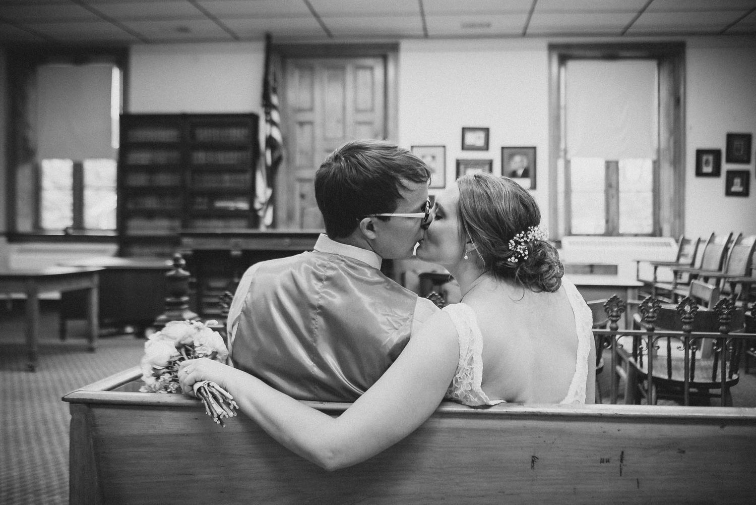 Black and white photos showing intimate moments in a reception venue setting.