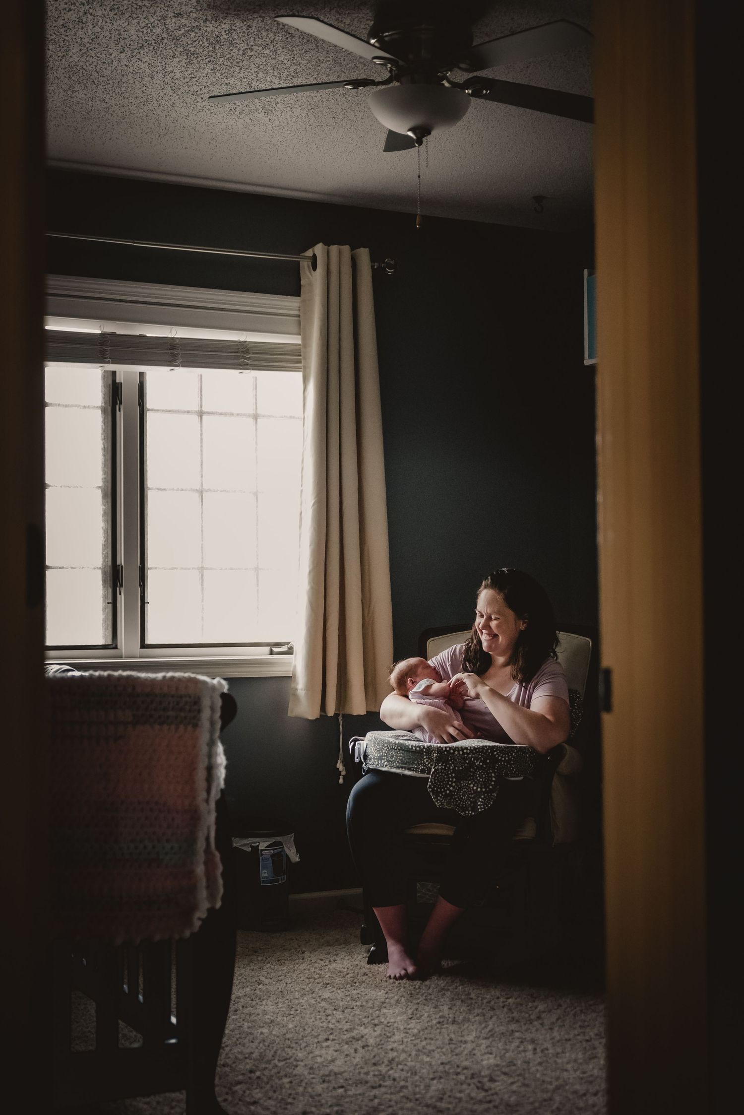 Moody indoor photography with dramatic window lighting in a dark room.