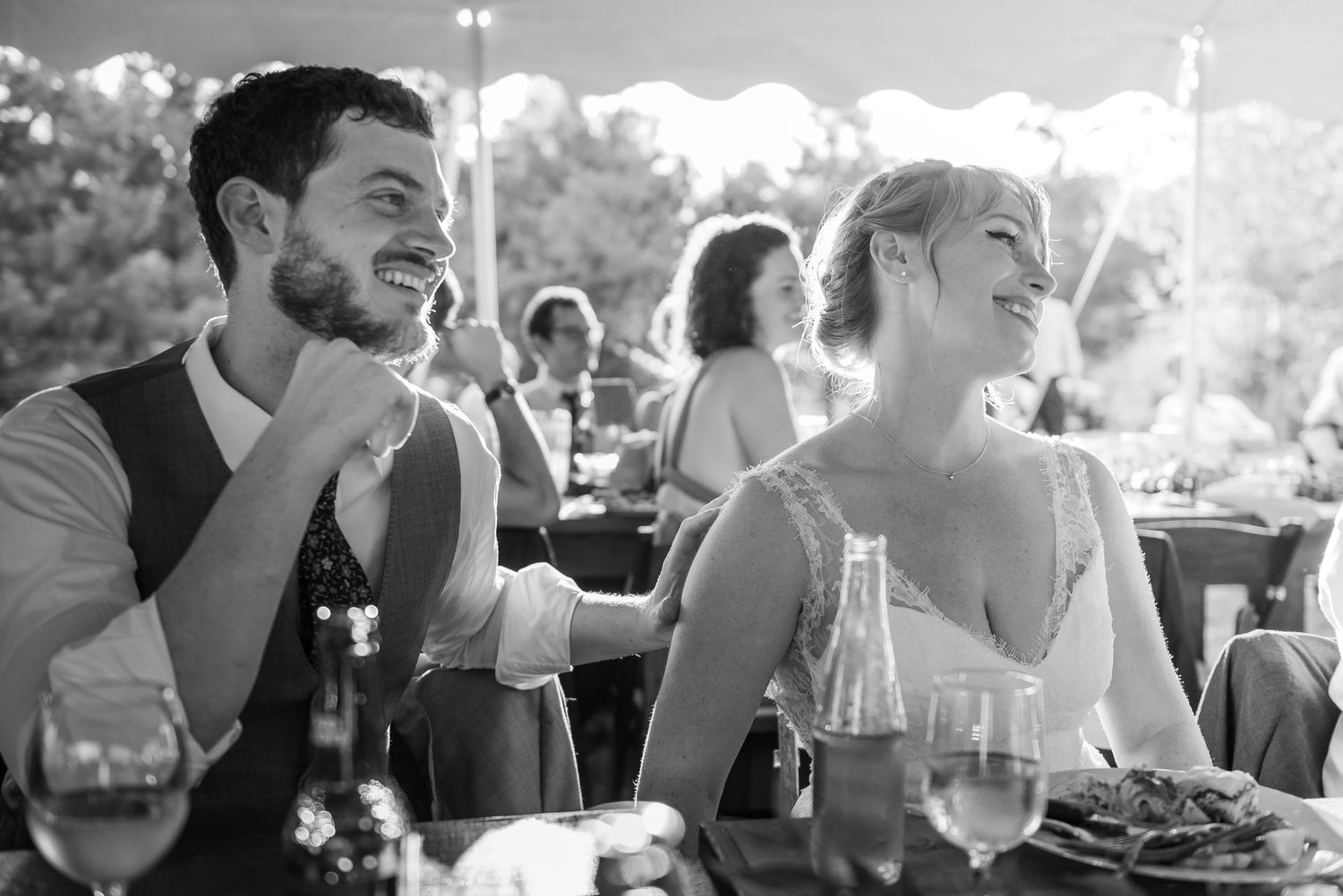 Candid reception moments captured during dinner with natural lighting and joyful atmosphere.