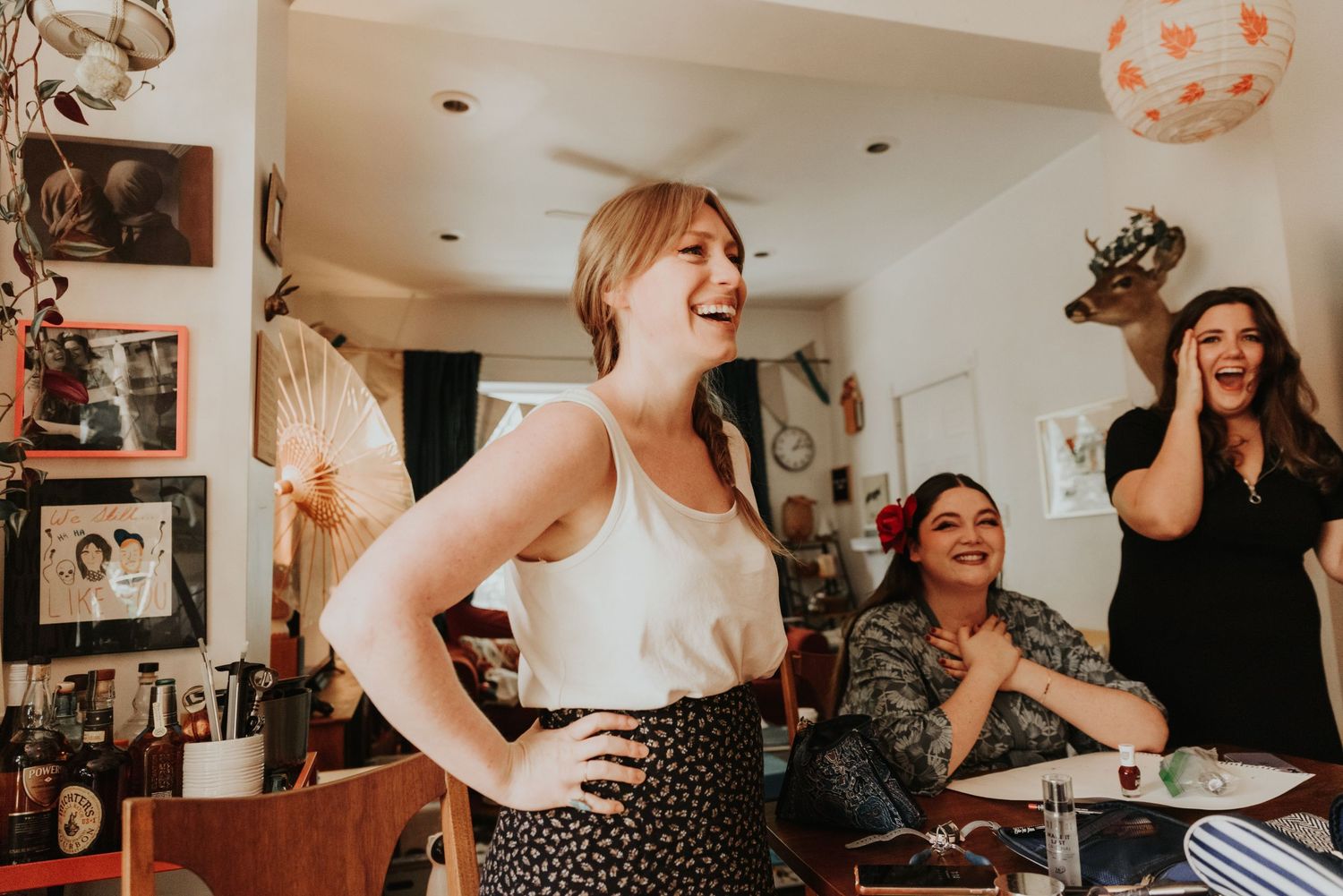 Candid getting ready moments captured in a warm, intimate indoor setting.
