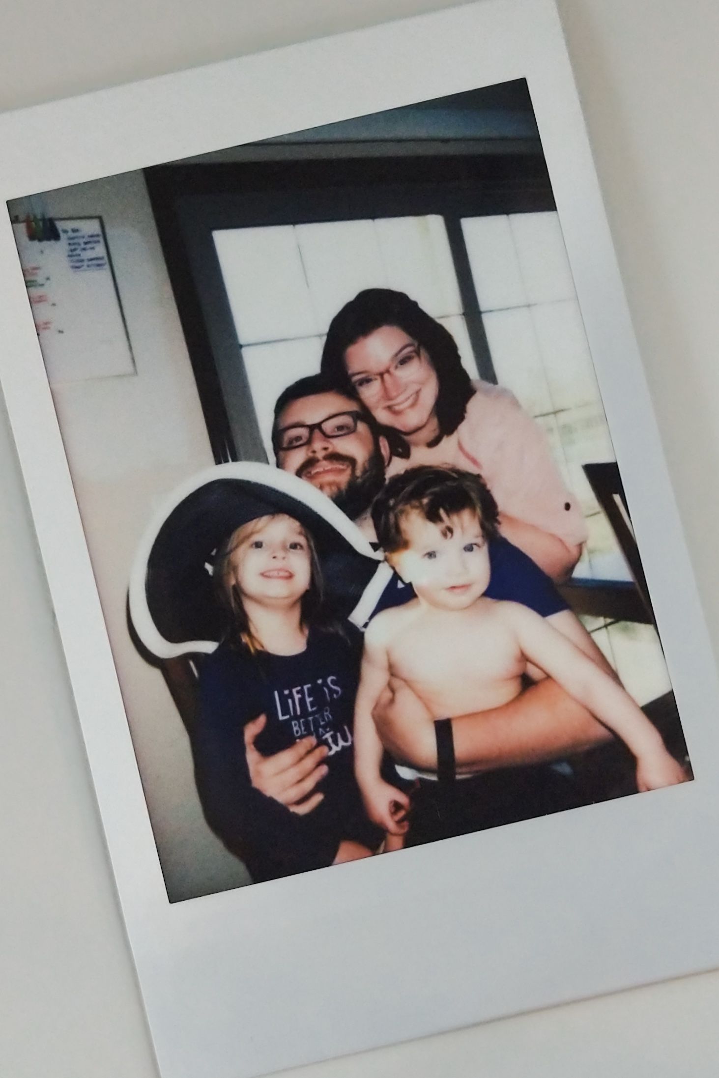 Collection of polaroid-style photos displayed on a light gray surface.