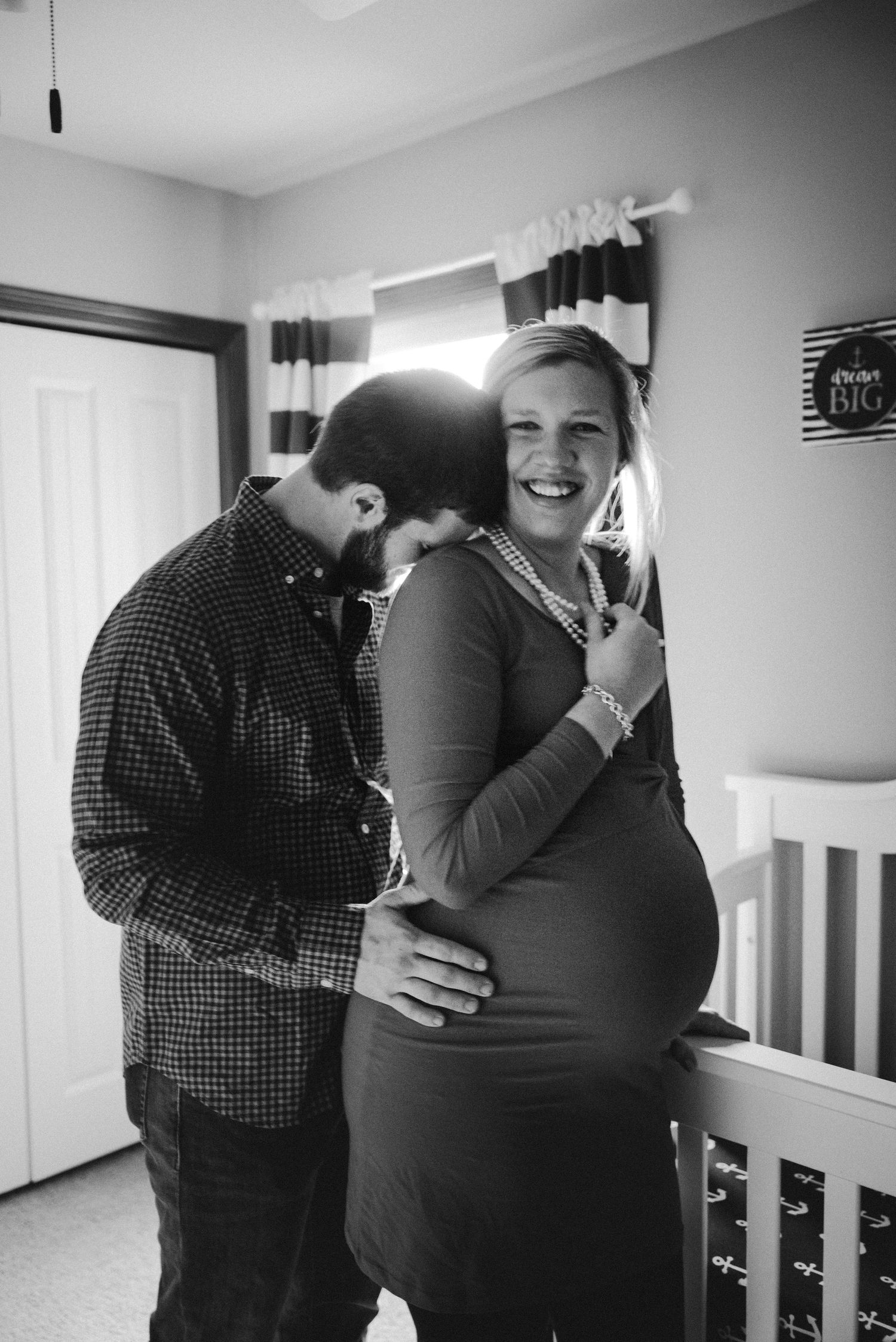 Series of intimate black and white maternity portraits in a nursery setting.
