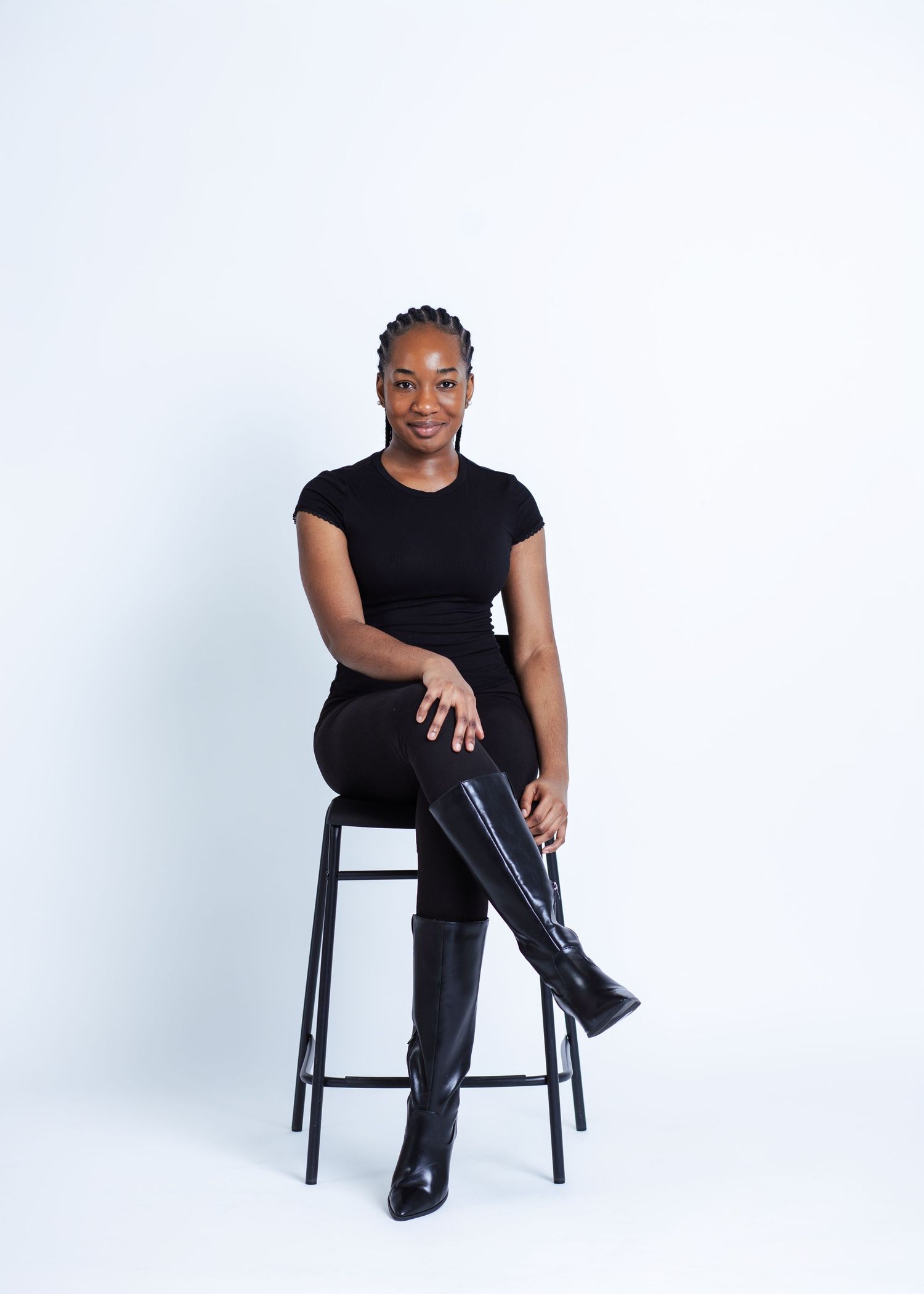 black lady with cornrow photoshoot in front of a white background in a studio in winnipeg for a model portrait session.