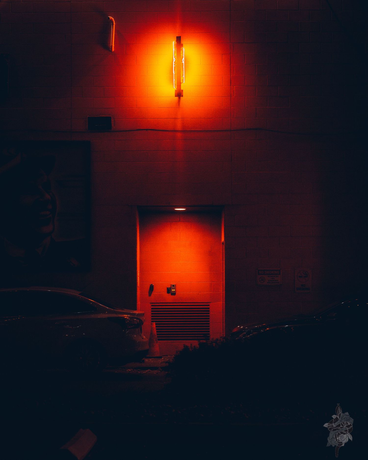 An orange streetlight casts an eerie glow in the darkness, creating a moody urban nighttime atmosphere by Porsche Aremia