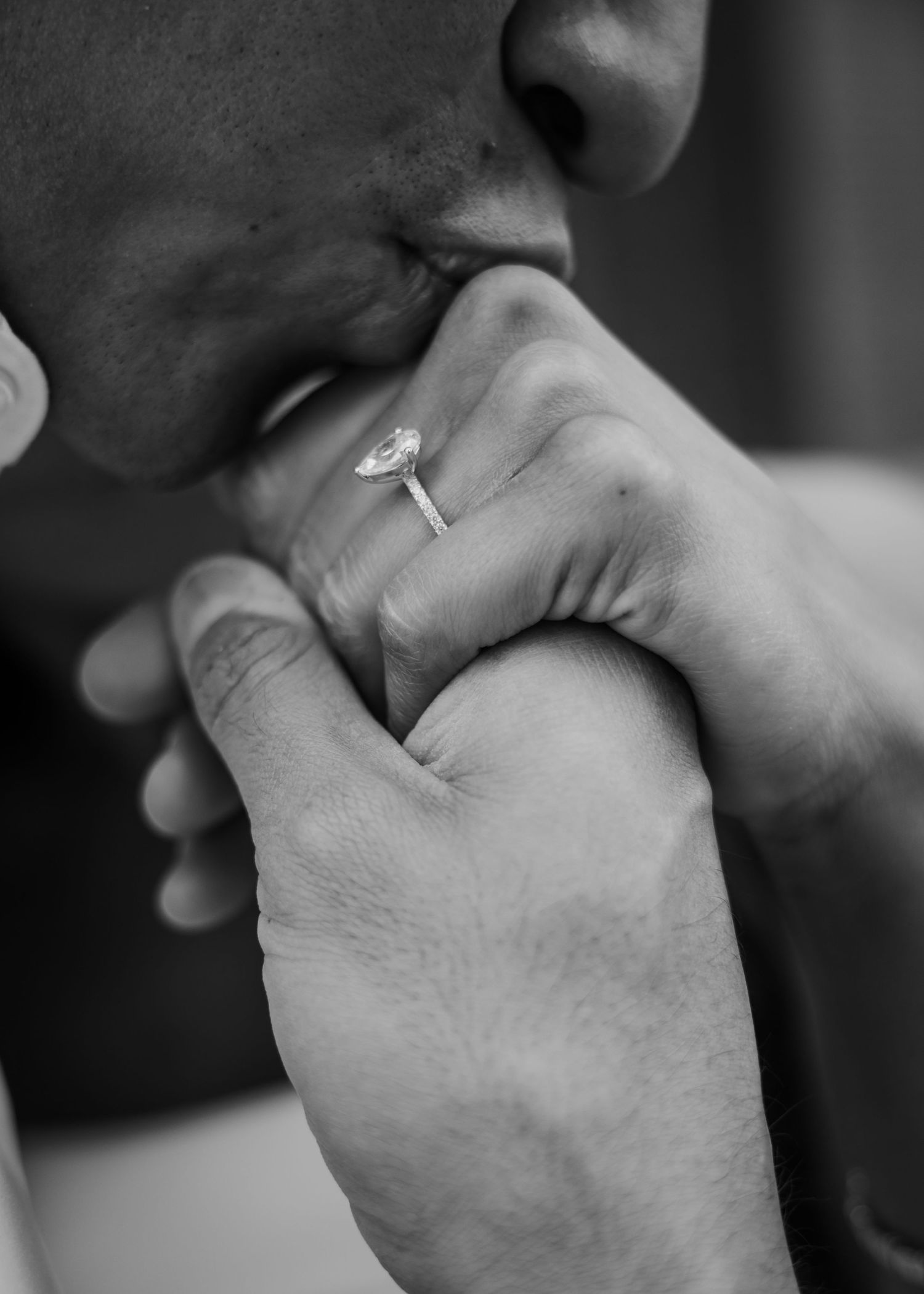 A series of black and white close-up photos showing hands with wedding rings in various intimate poses.