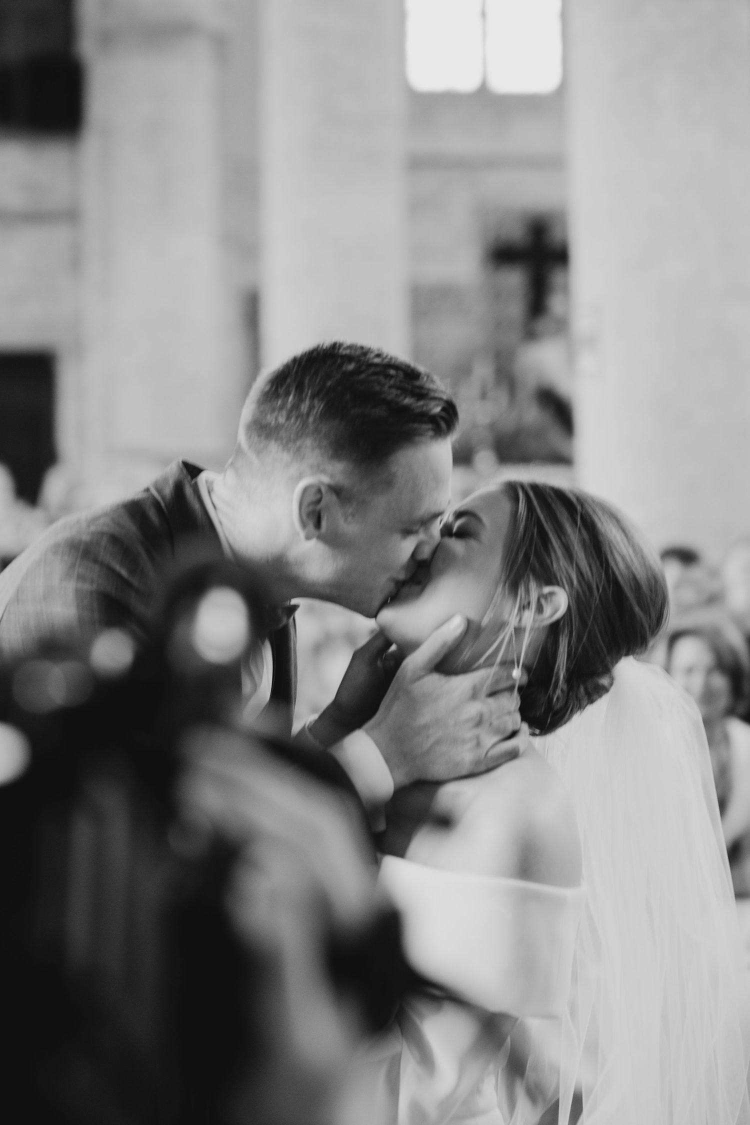A tender moment captured during a wedding ceremony in a church setting.