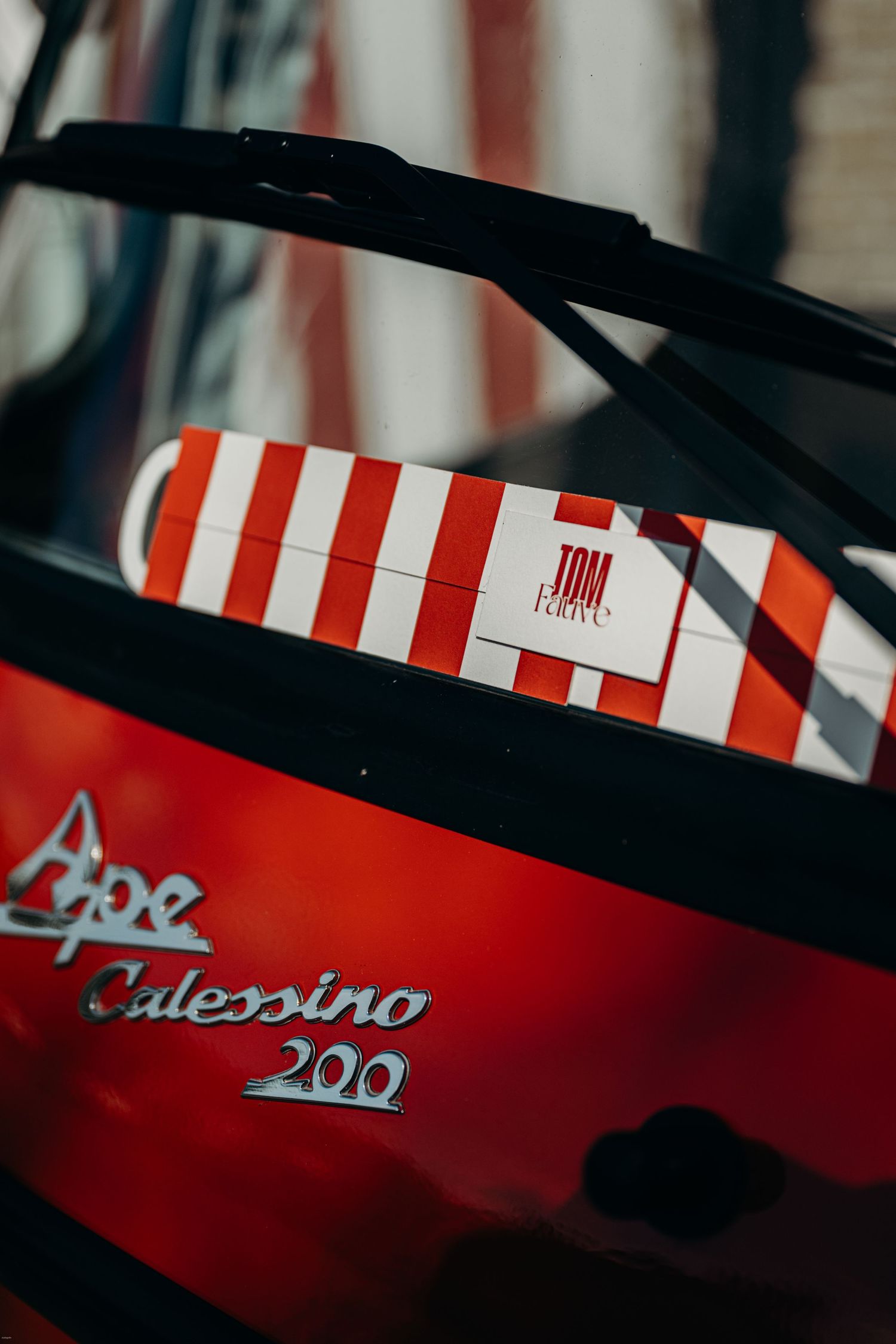 Close-up detail of a vintage red and white striped classic car.