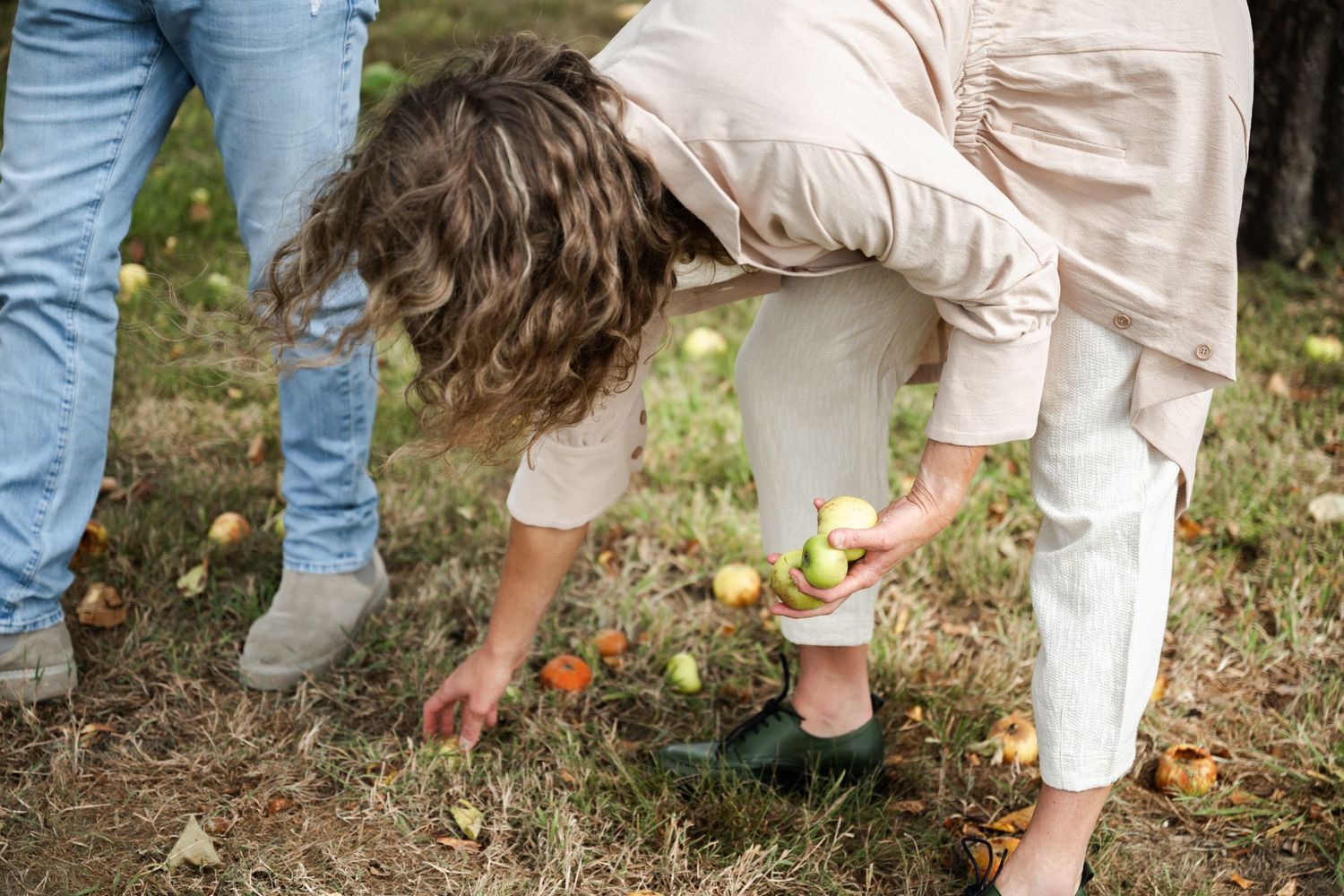 Wedding guests in casual attire gathering outdoors on grass.