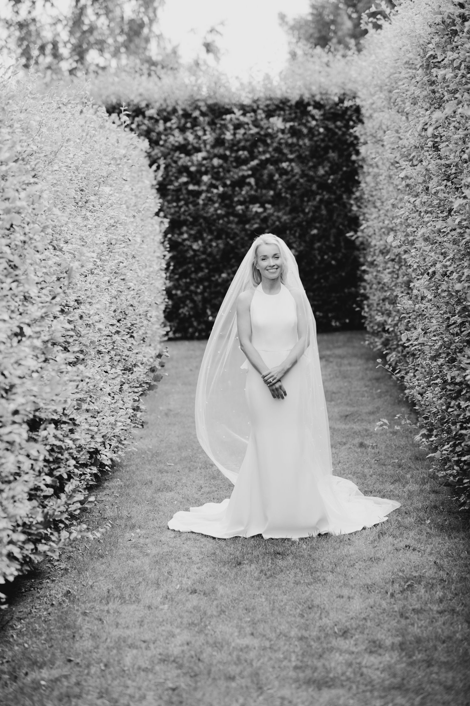 A sequence of artistic bridal portraits showing a white dress flowing on garden grass.