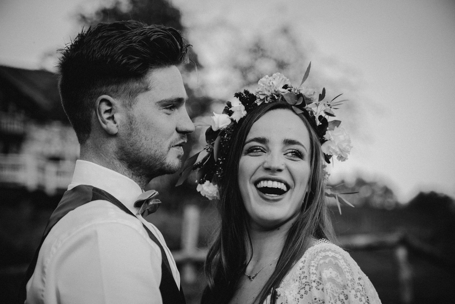 Black and white wedding portrait showing joyful moments between newlyweds.